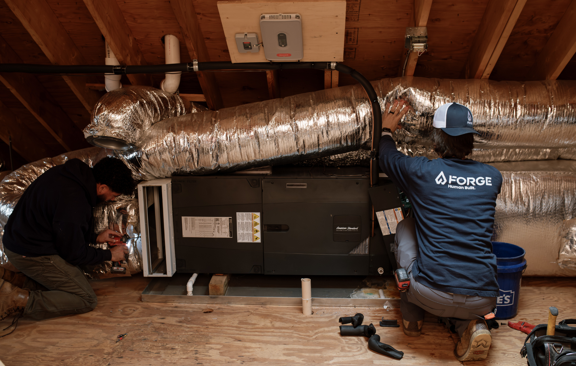 Forge HVAC technicians installing a mini-split in Massachusetts