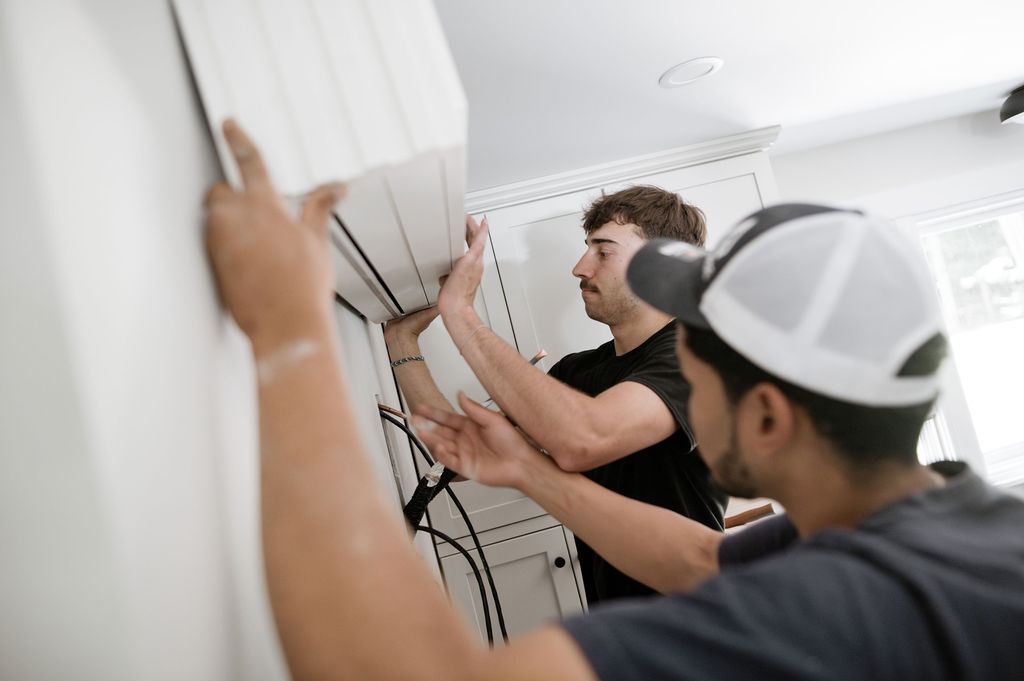 Two Forge installers connecting the line set behind an indoor head