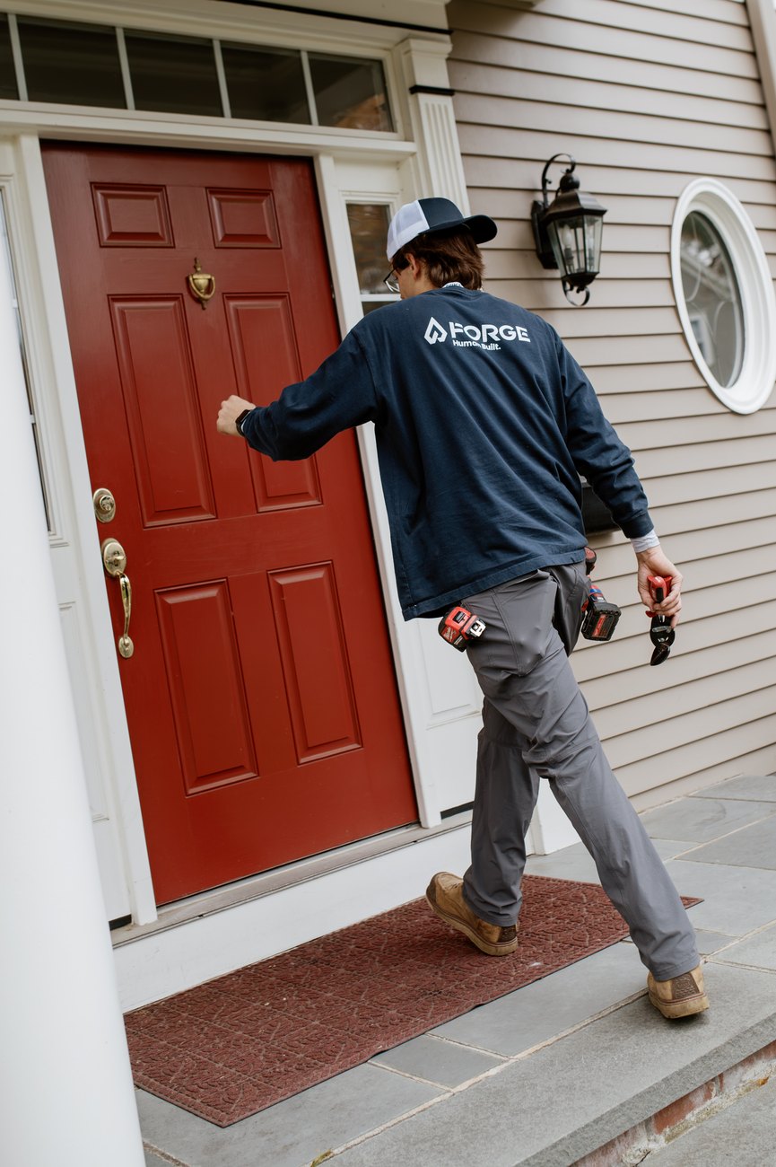 A Forge crew member arriving at the front door of a home