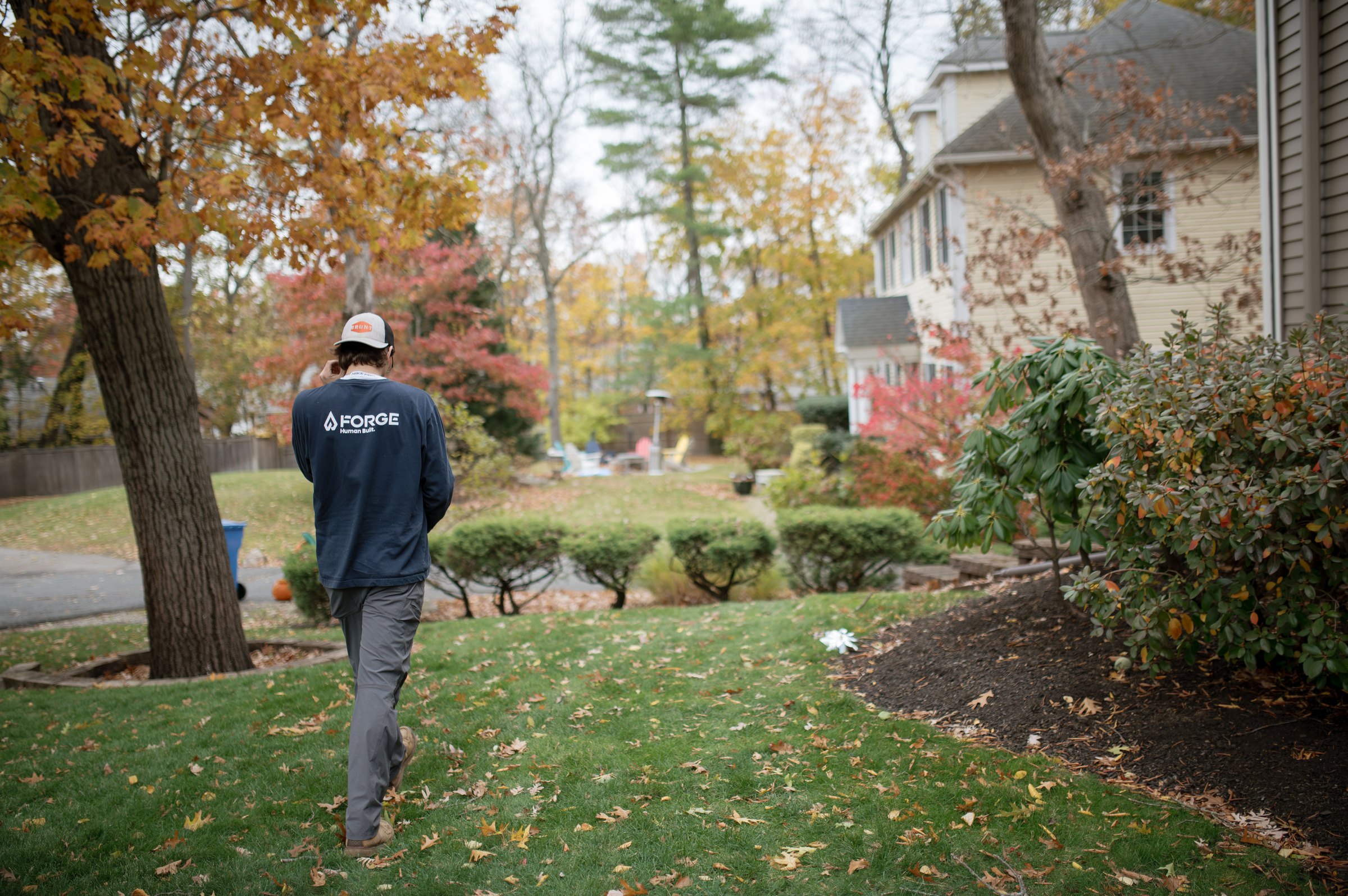 A Forge crew member walking up to a Massachusetts home in the fall
