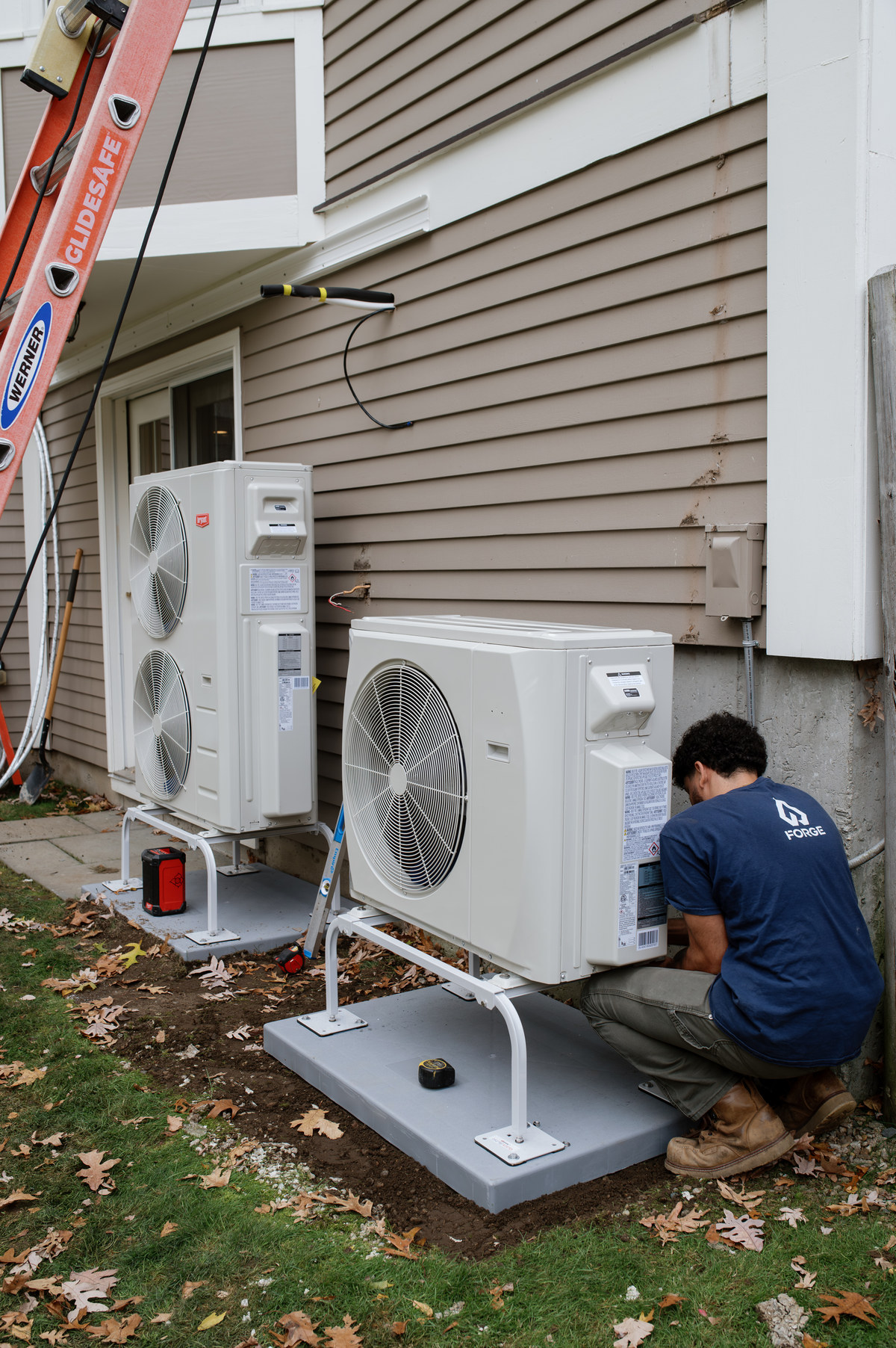 A Forge installer connecting a pair of outdoor heat pump units
