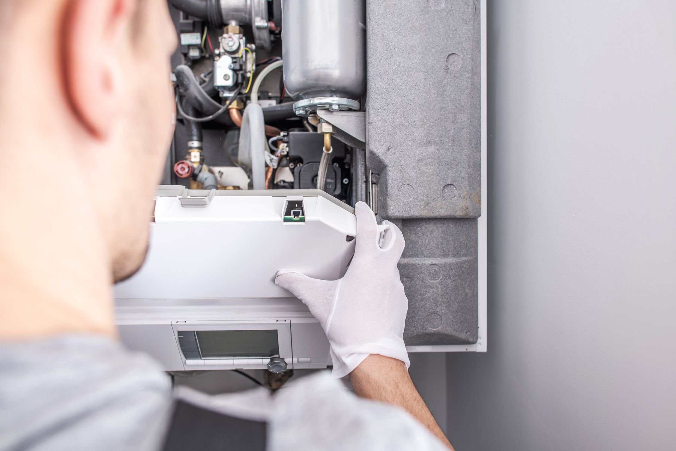 HVAC technician checking refrigerant levels on air conditioning system in Athens, GA