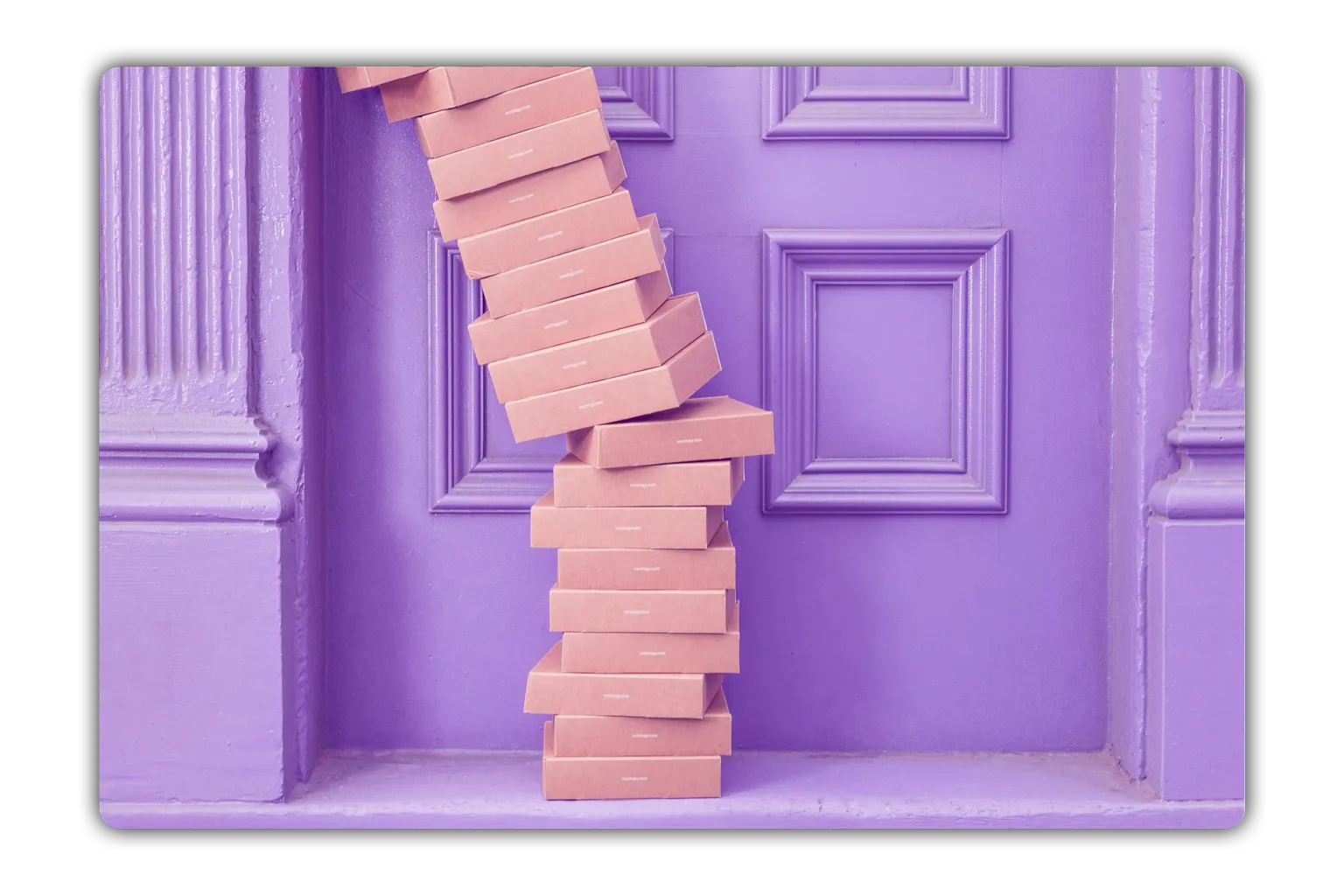 Stack of light brown cardboard boxes leaning against a purple paneled wall and a panel with molding.