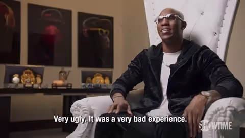 Man sitting in a large white chair saying, "Very ugly. It was a very bad experience."