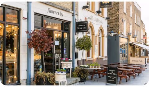 Street in Clapham, London, showing a coffee shop and flower shop from the outside