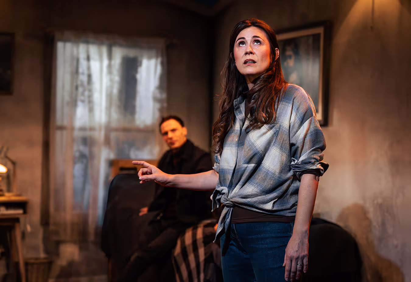 A woman standing next to a man in a living room