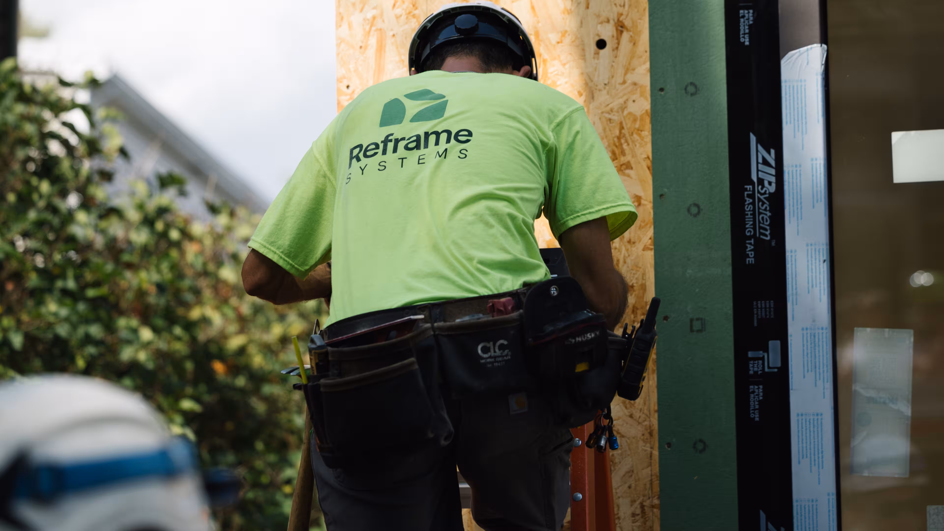 Reframe Systems worker assembling a ZIP System-sheathed module at a build site