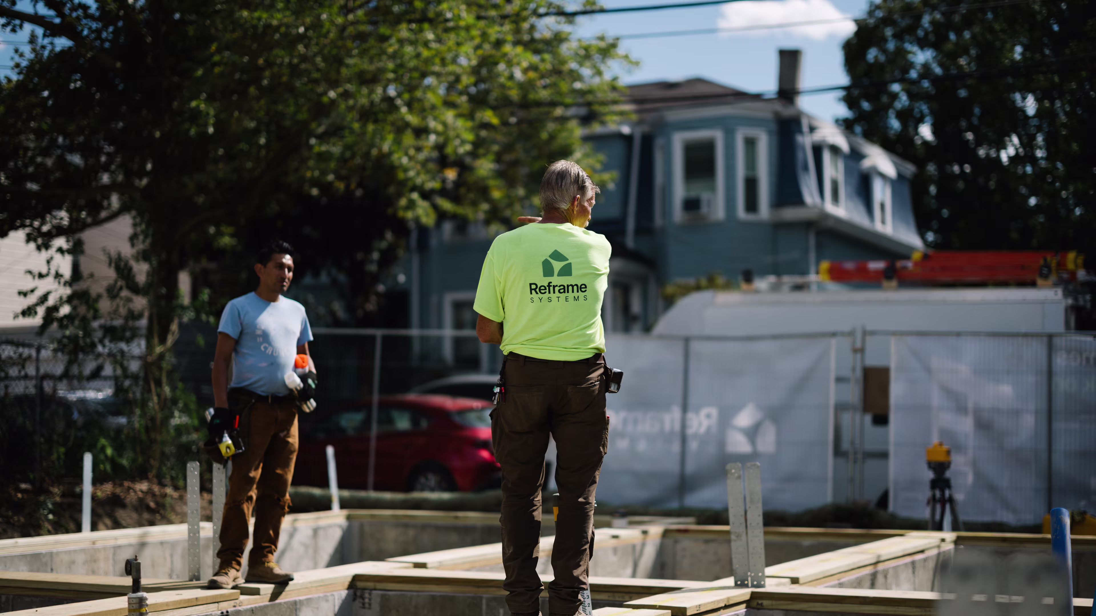 Two Reframe Systems workers at a residential modular home construction site