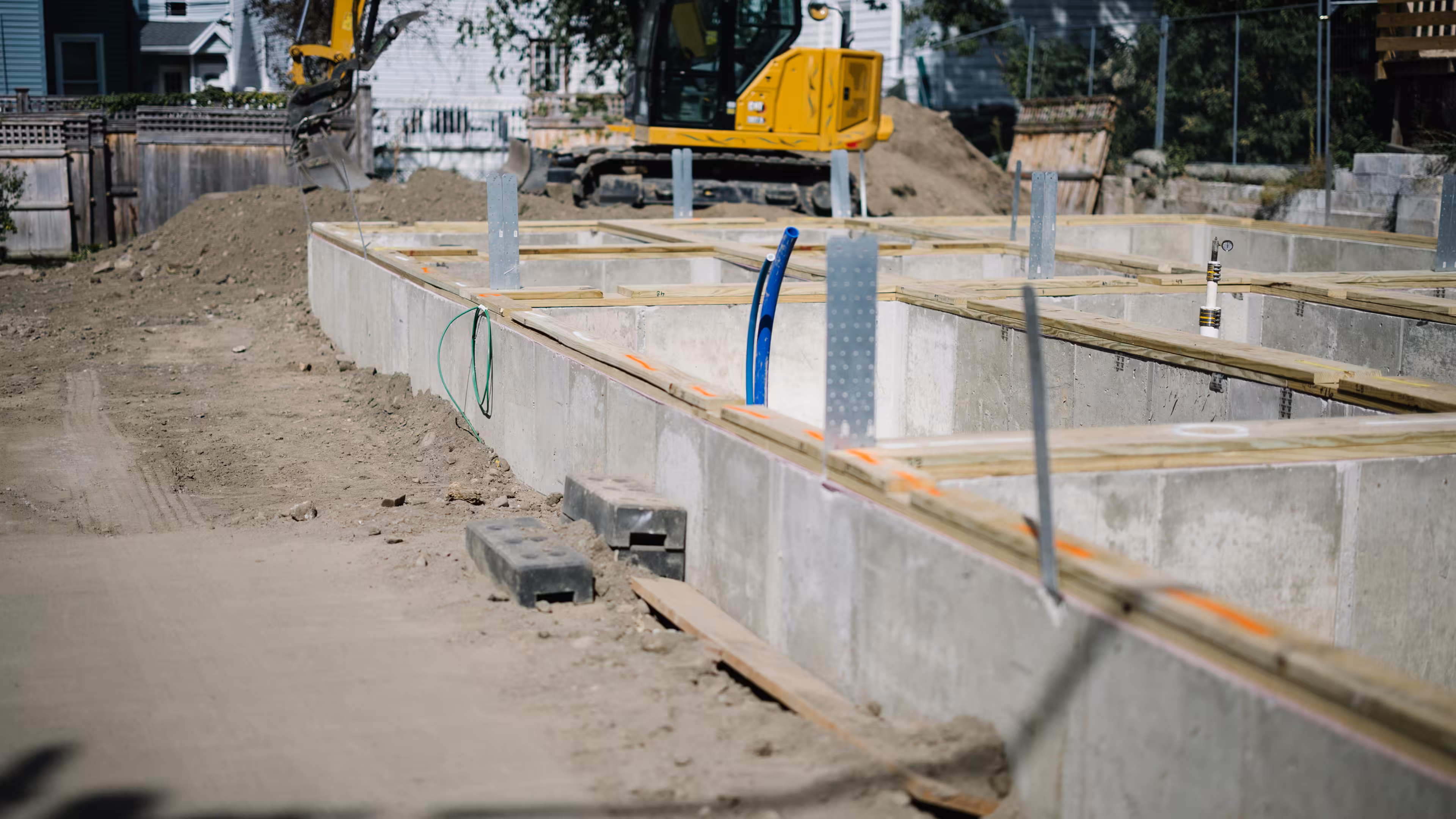 Poured concrete foundation at an early-stage modular home construction site