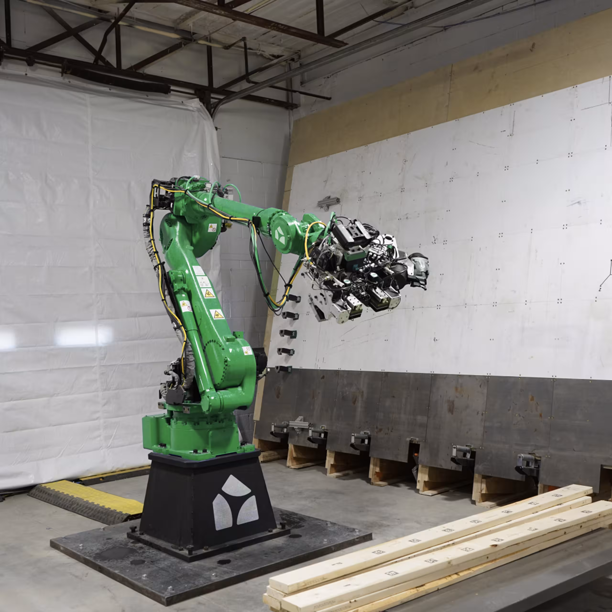 Industrial robotic arm with a gripper handling lumber in the microfactory