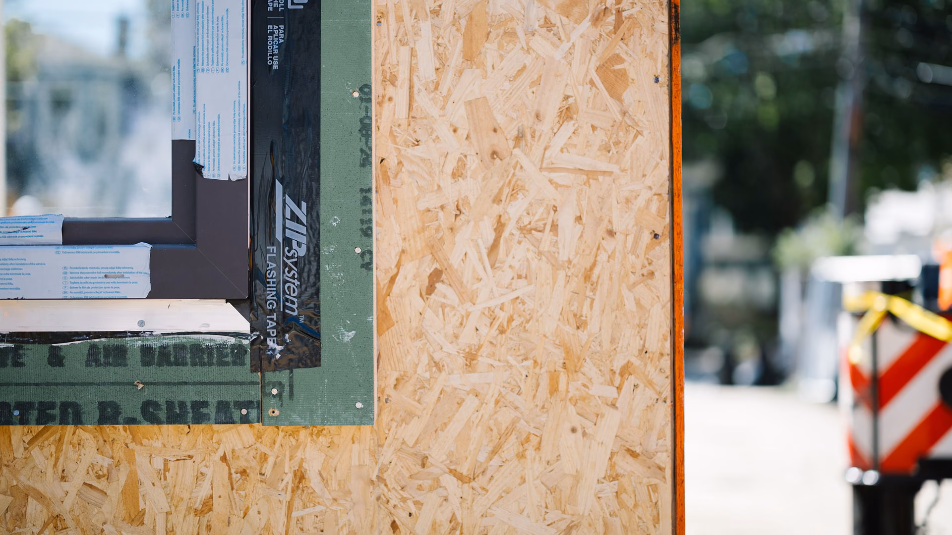 Close-up of a ZIP System-sheathed wall corner with flashing tape on a modular unit