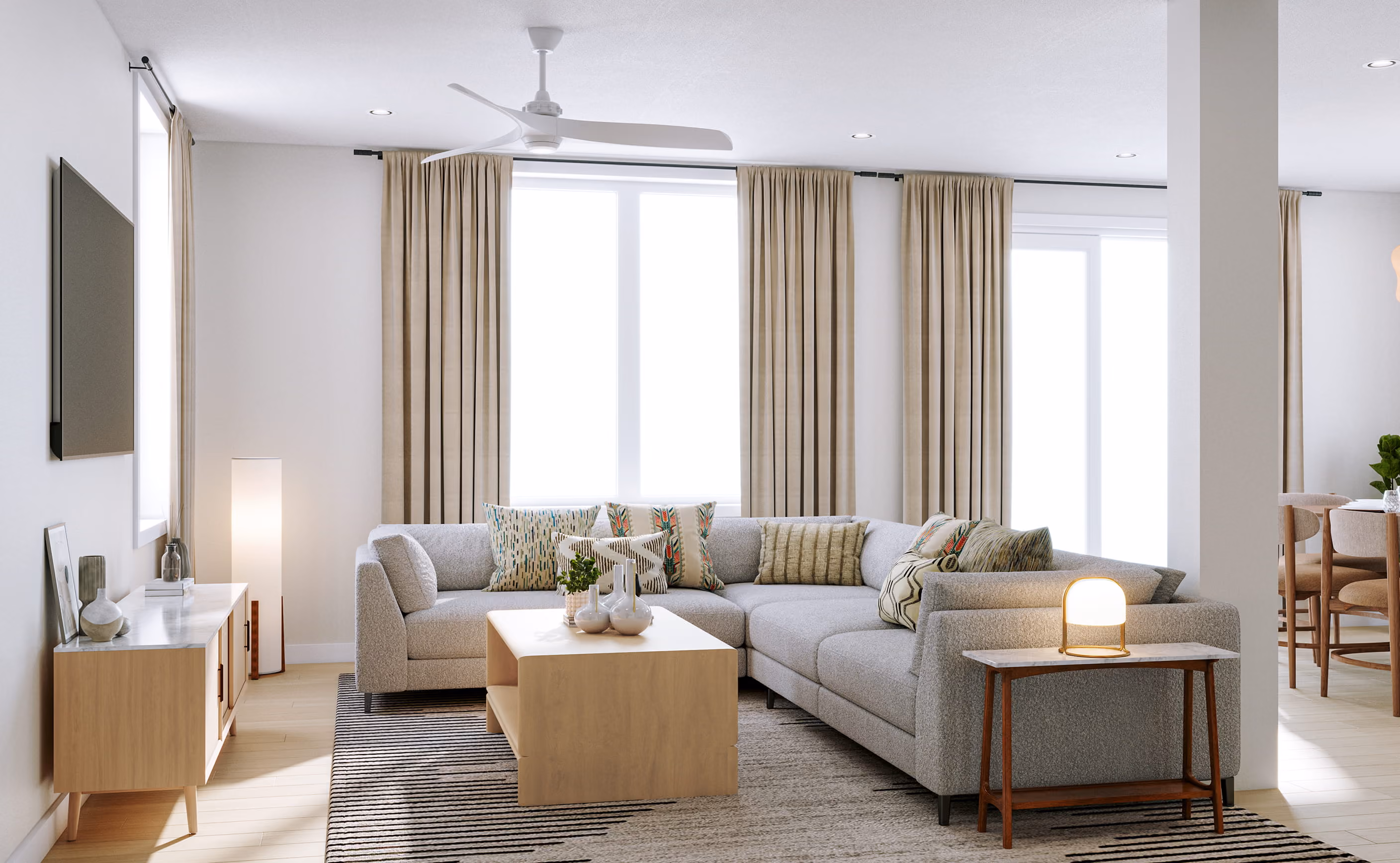 Neutral living room with large windows, two sofas, armchairs, and a central coffee table.