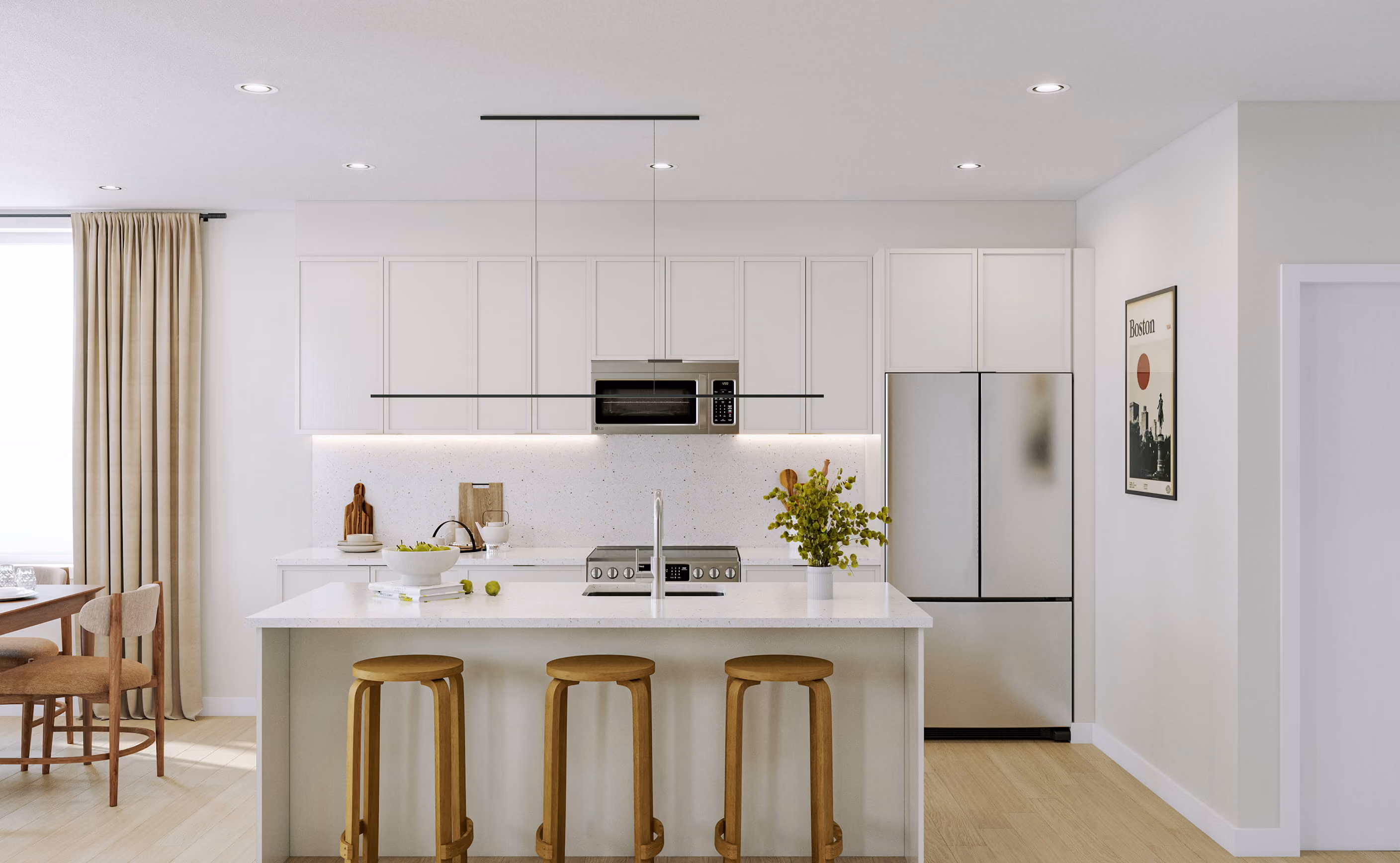 Bright white kitchen with a large island, three bar stools, modern appliances, and an adjoining dining area.