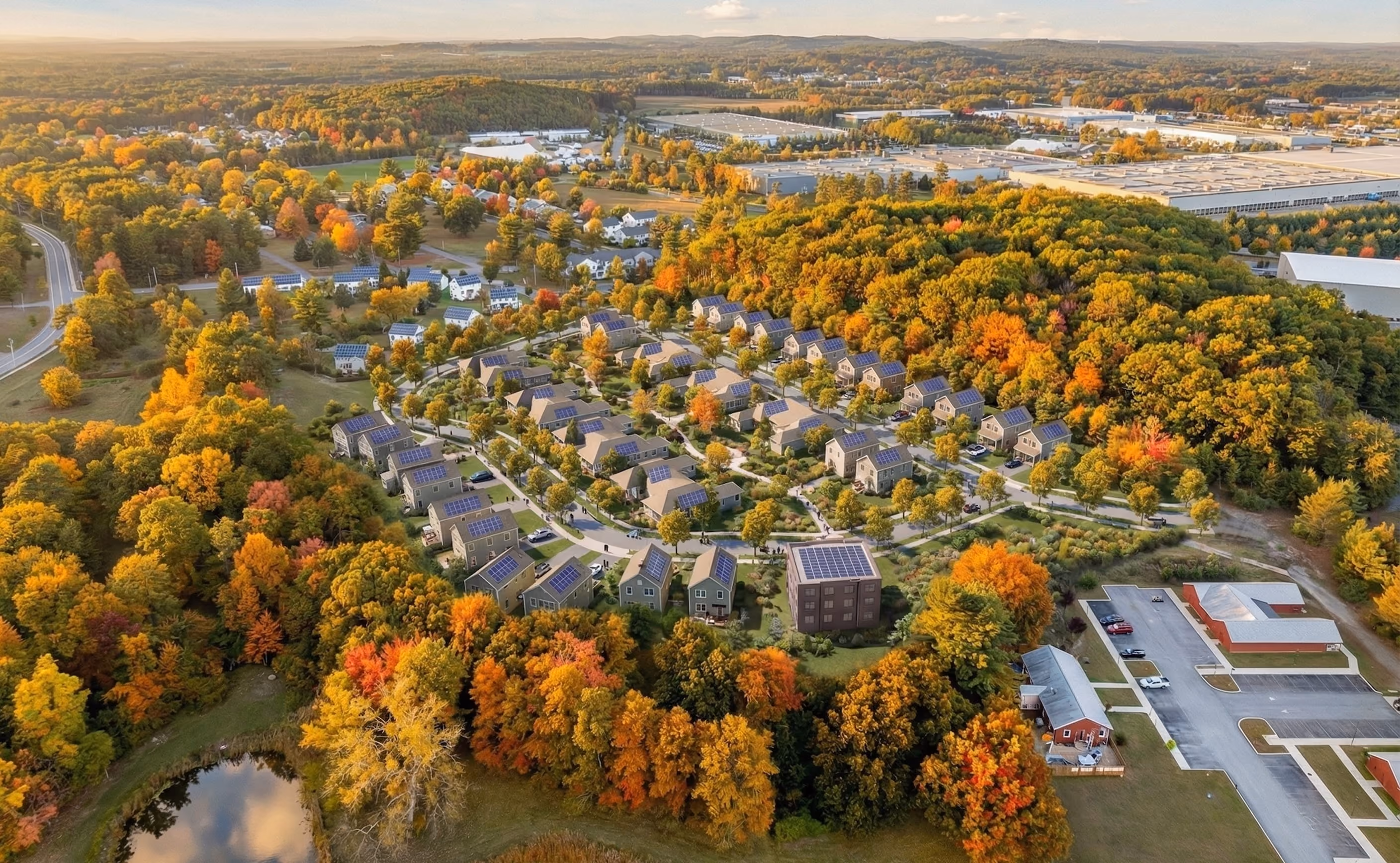 Aerial view of the completed Adams Circle neighborhood amid colorful autumn trees.