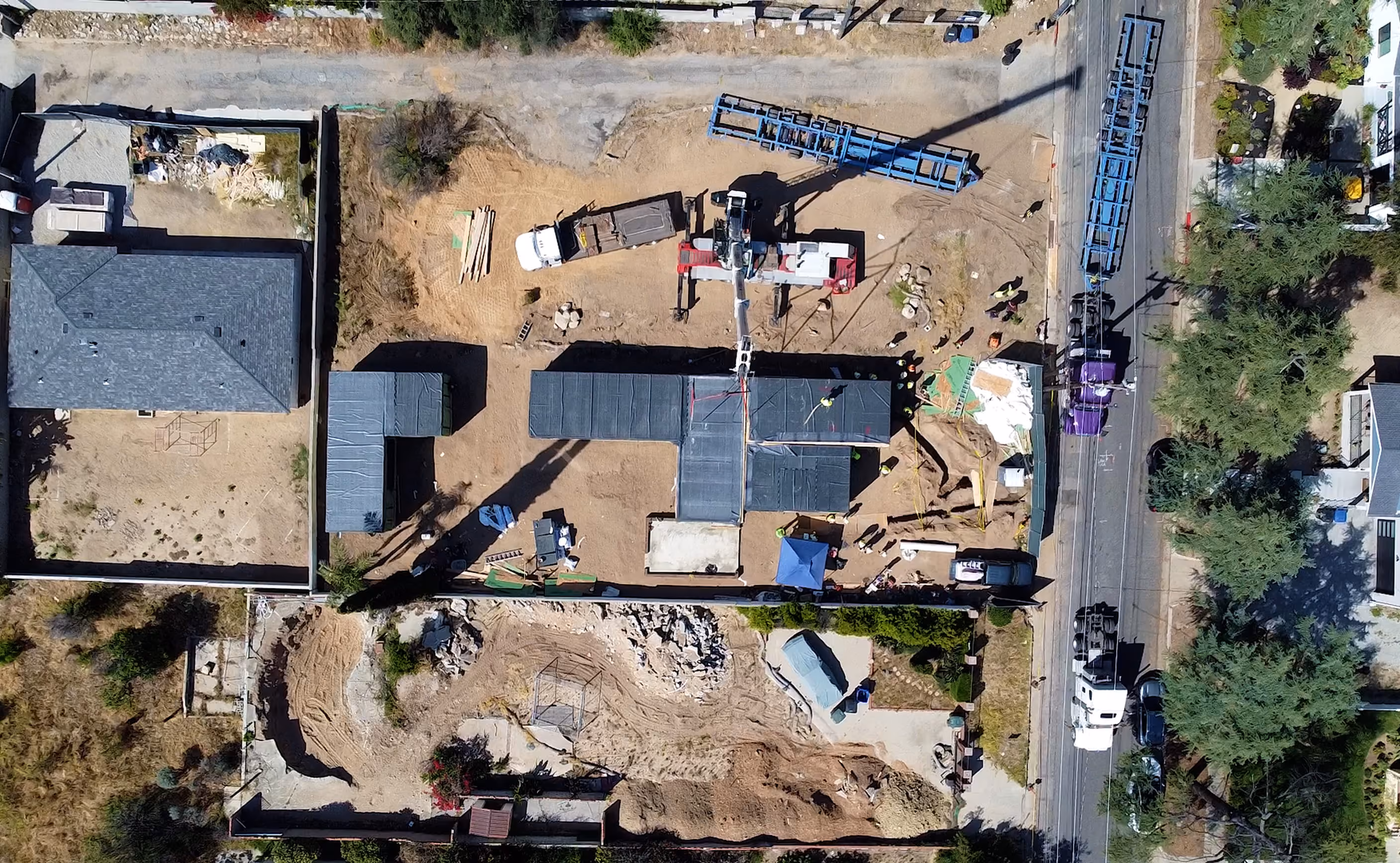 Top-down drone view of the Glenrose construction site and modular home installation