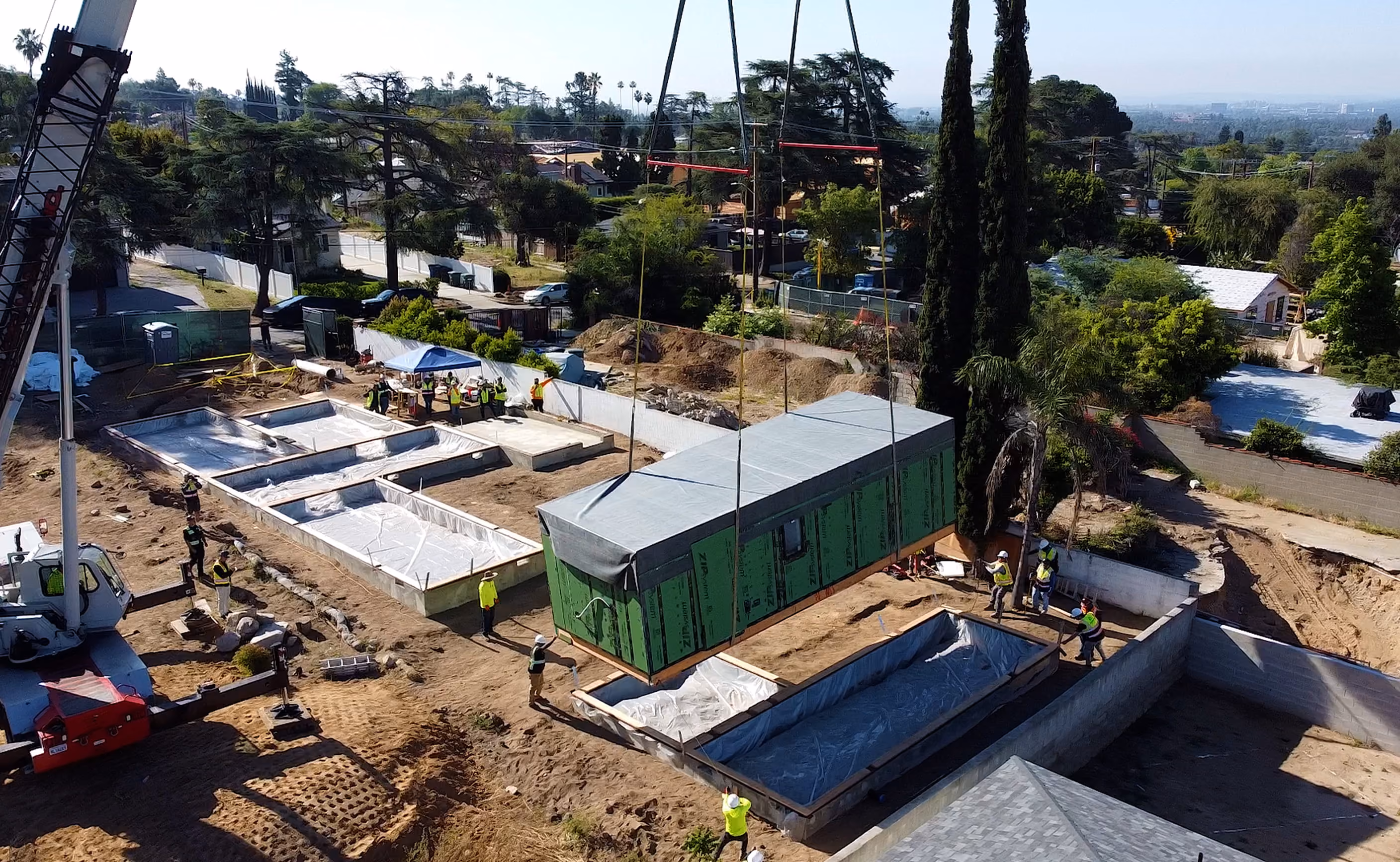 Aerial view showing the Glenrose home under construction within the surrounding neighborhood