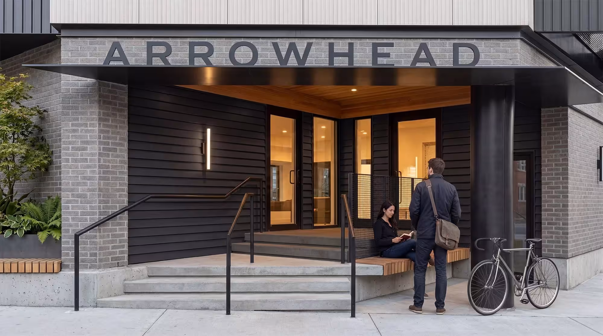 Arrowhead condominium entrance in Roxbury, Boston, featuring black wood-slat canopy and lobby built with Reframe Systems' modular construction.