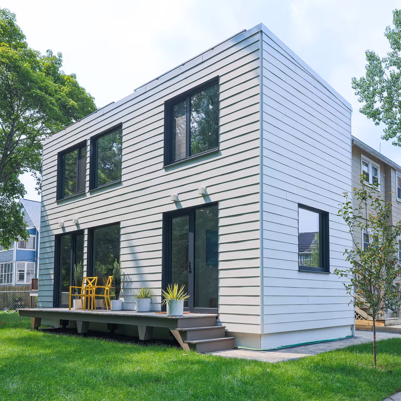 Modern two-story modular home with white siding