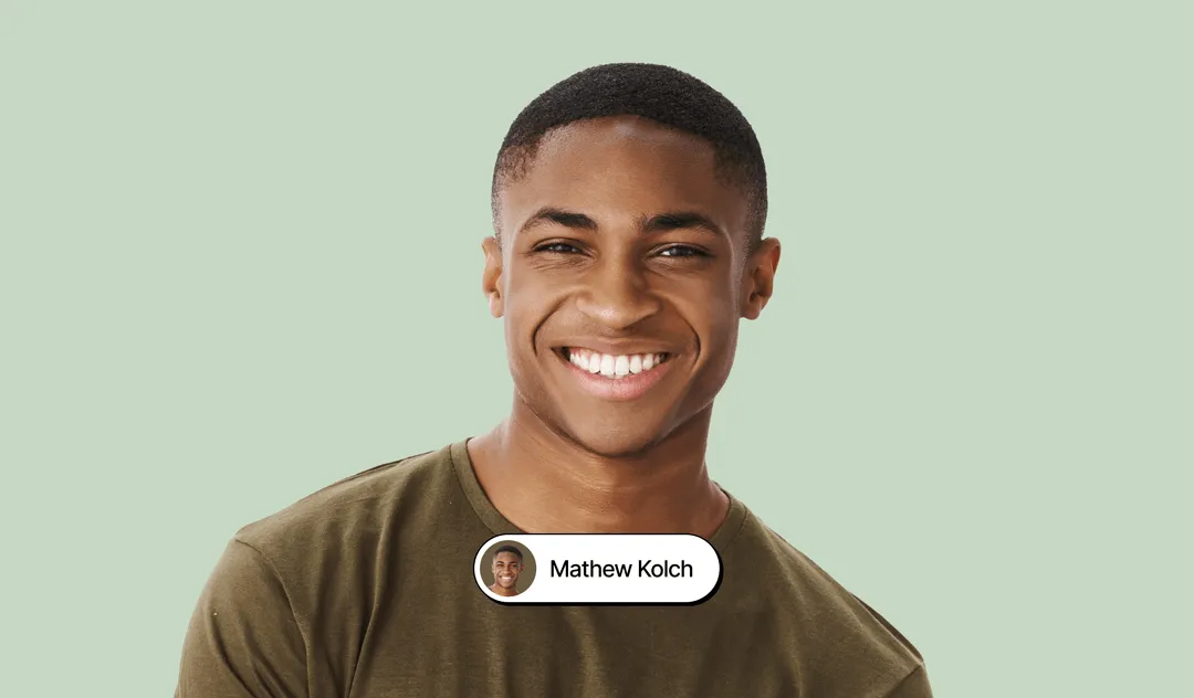 Man on green tshirt smiling to the camera