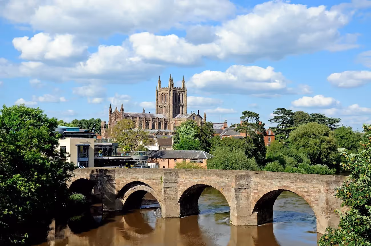 View of Hereford cathedral from river on sunny day.