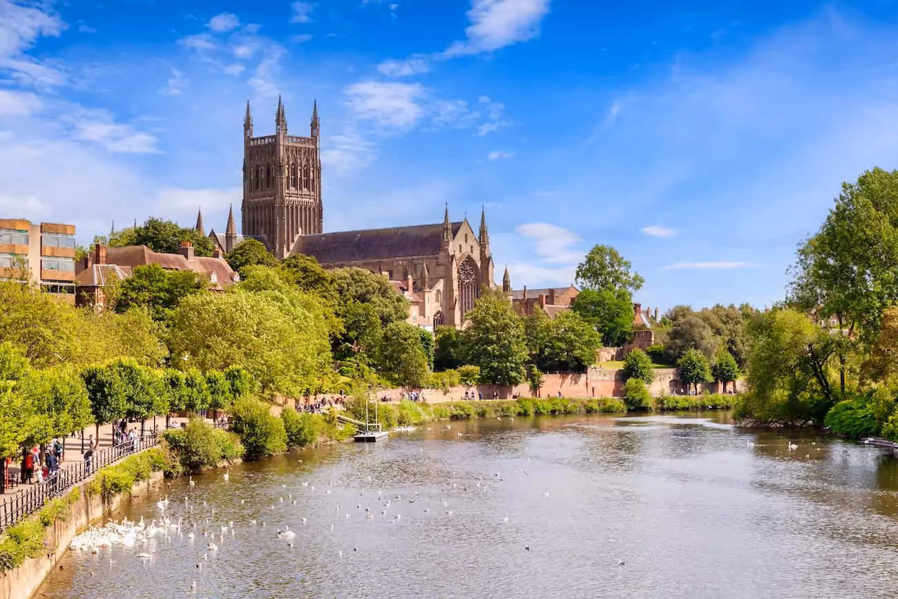 View of Worcester cathedral from river on sunny day.