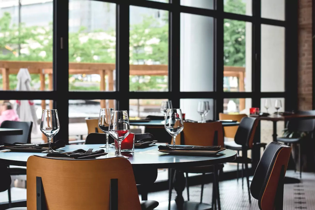 An empty restaurant with all tables laid.
