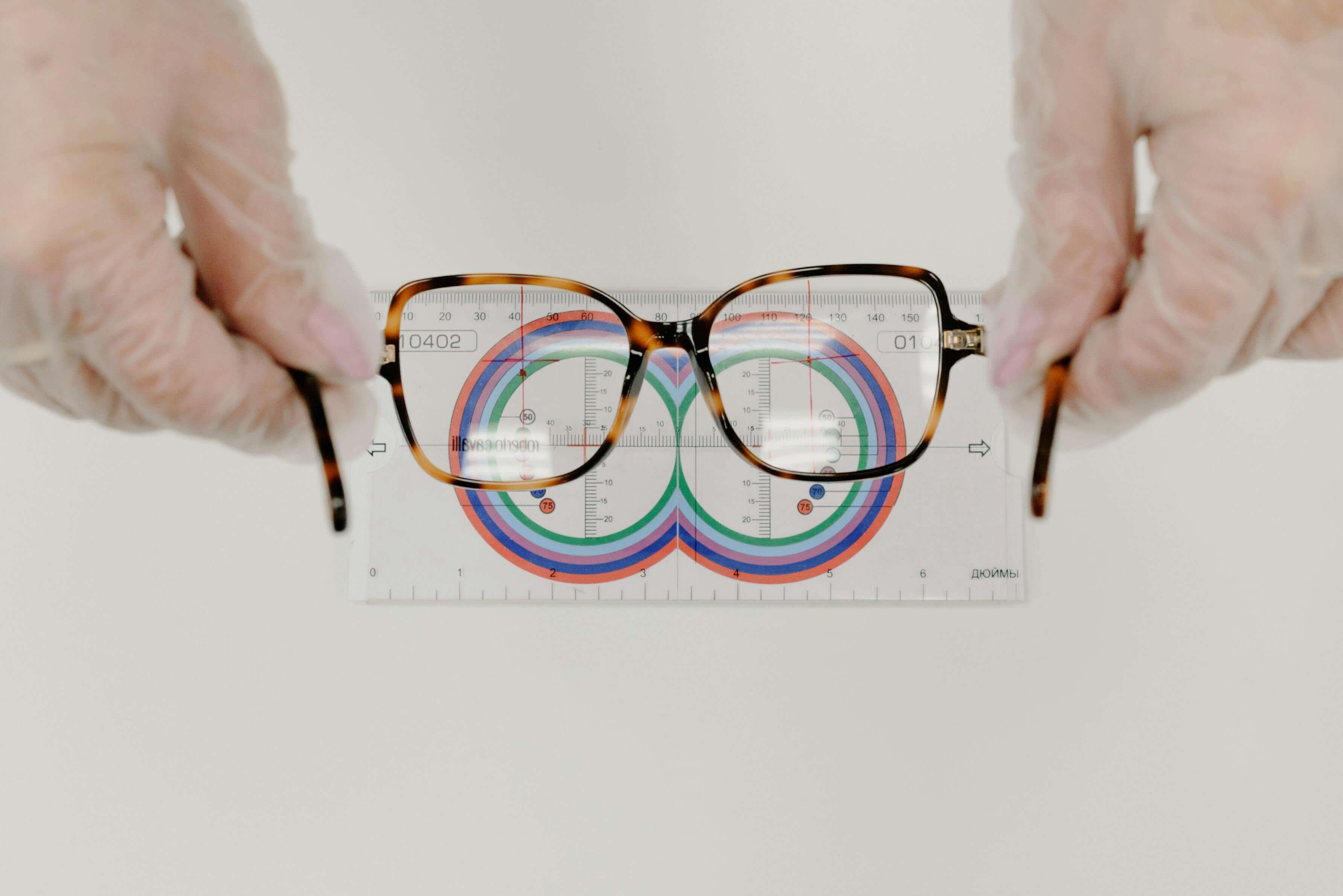 Tortoiseshell glasses on measuring scale with colorful circular measurement guides