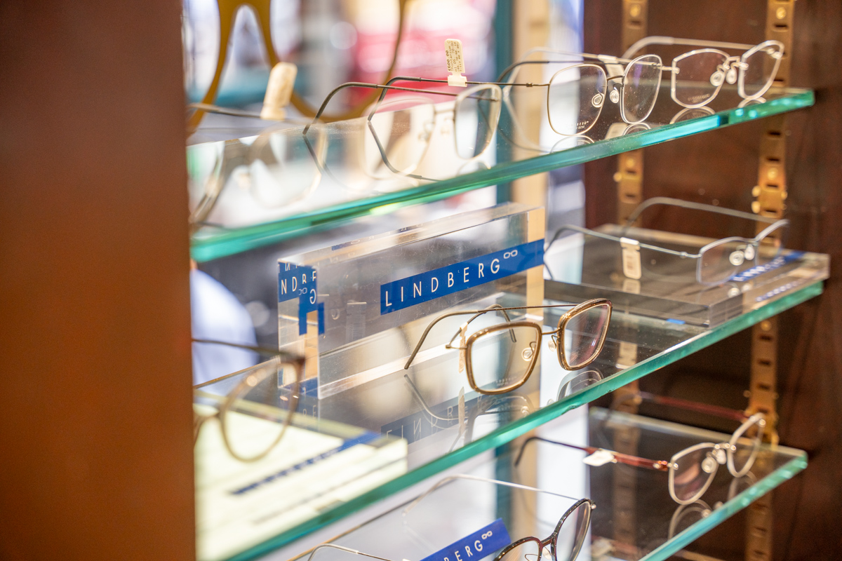 Lindberg eyeglasses displayed on glass shelves in an optical store