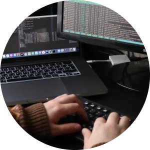 Close-up of a developer typing on a keyboard while working on an AI-powered application, showcasing the use of advanced tools for cloud-based software development.