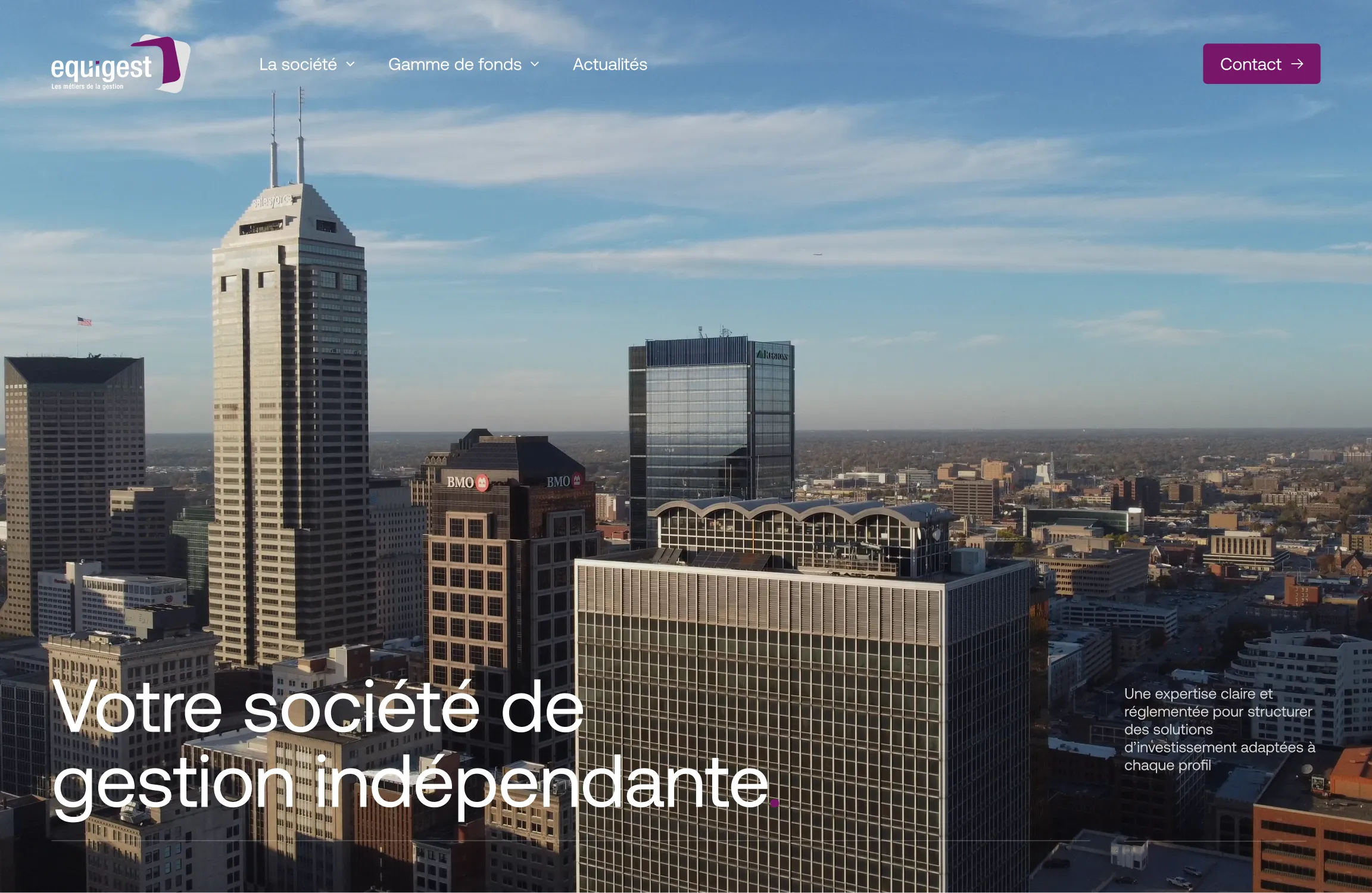 Horizon de la ville avec de grands immeubles de bureaux sous un ciel bleu avec des nuages vaporeux.