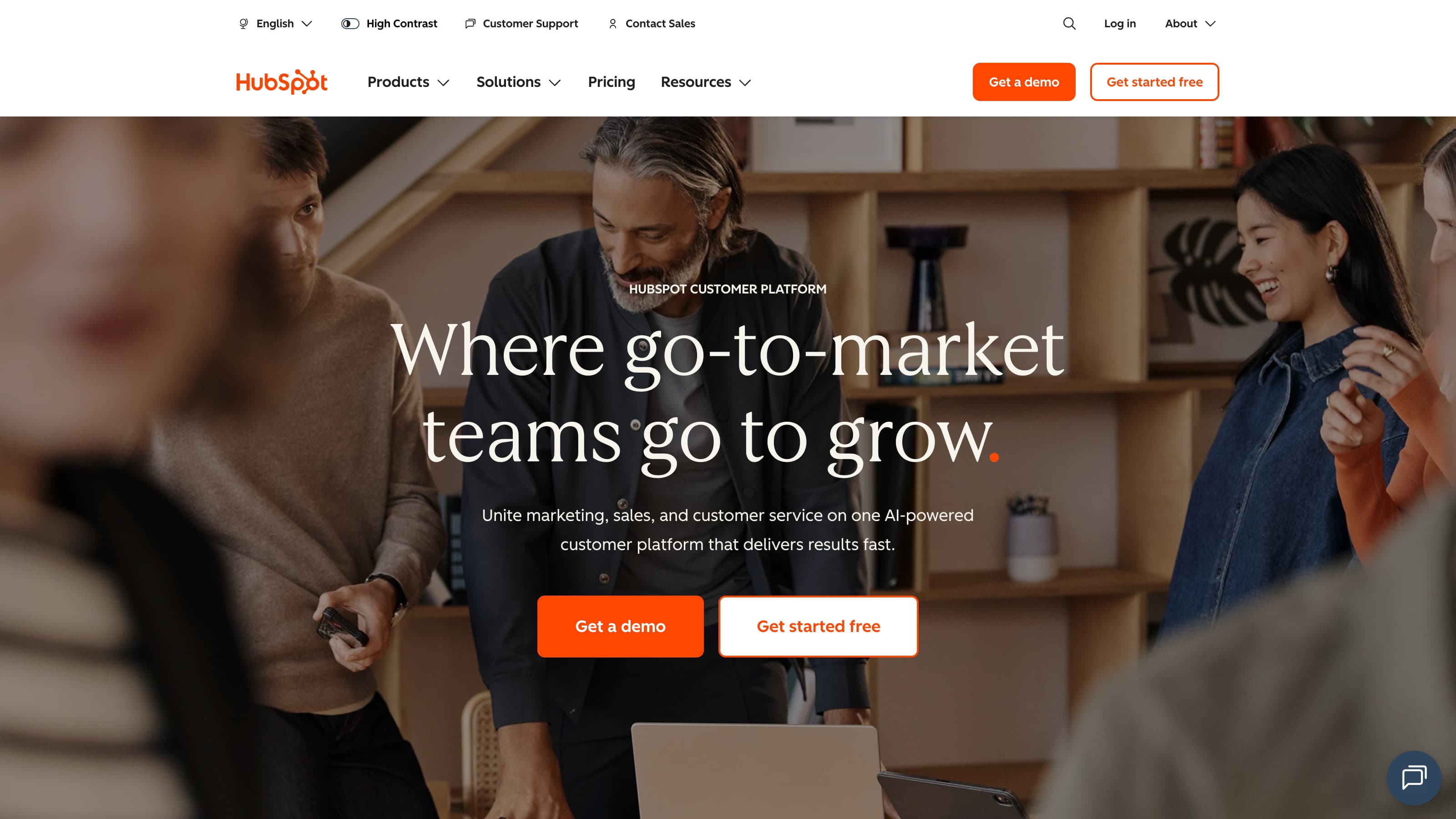 English version of the HubSpot homepage emphasizing simplified tech stacks for marketing, sales, and support teams, with an interactive customer data visual.