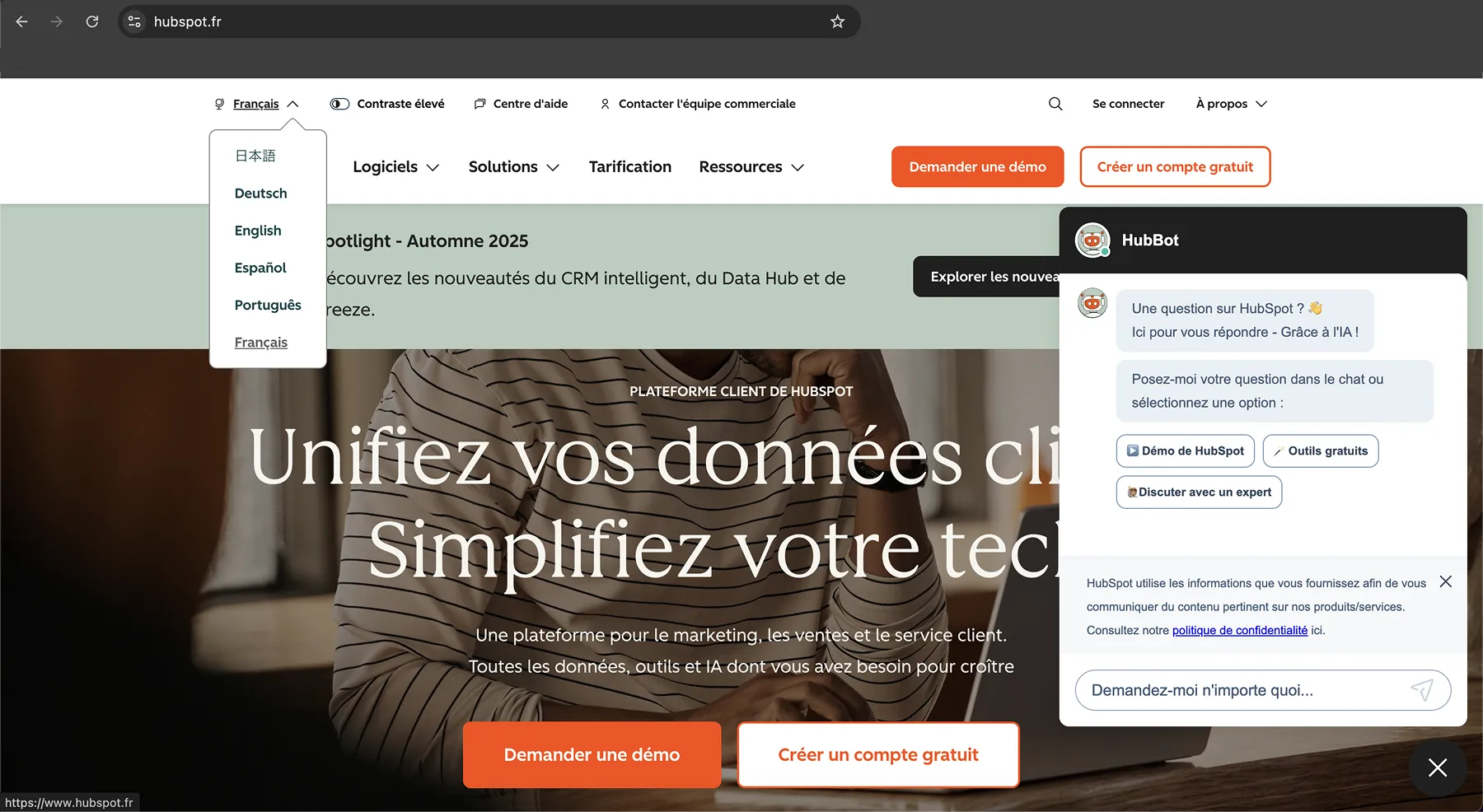  Page d’accueil du site français de HubSpot avec un menu de sélection de langue et un chatbot alimenté par l’IA.