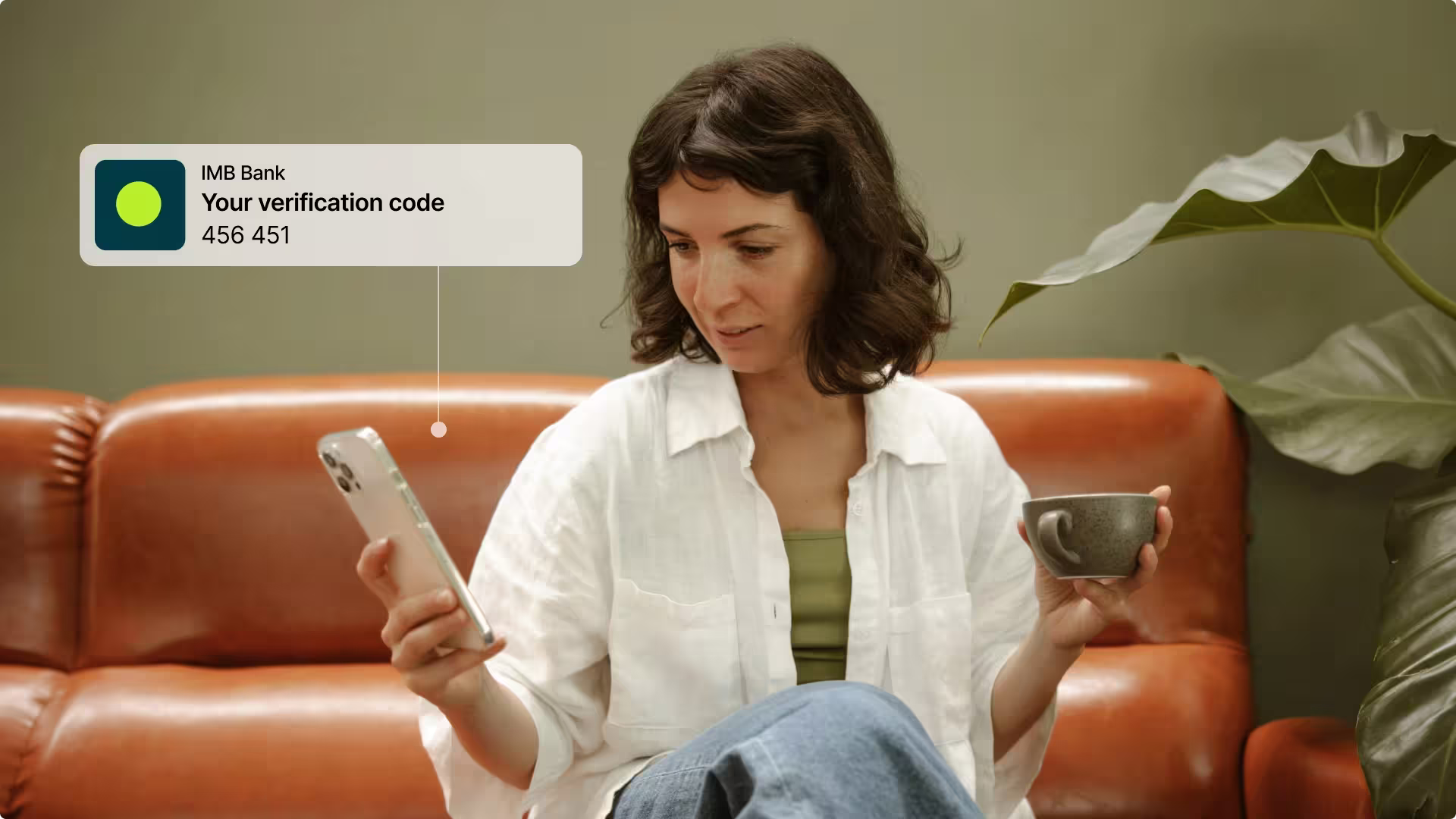 A woman holding her phone, with a notification window showing the reception of a verification code
