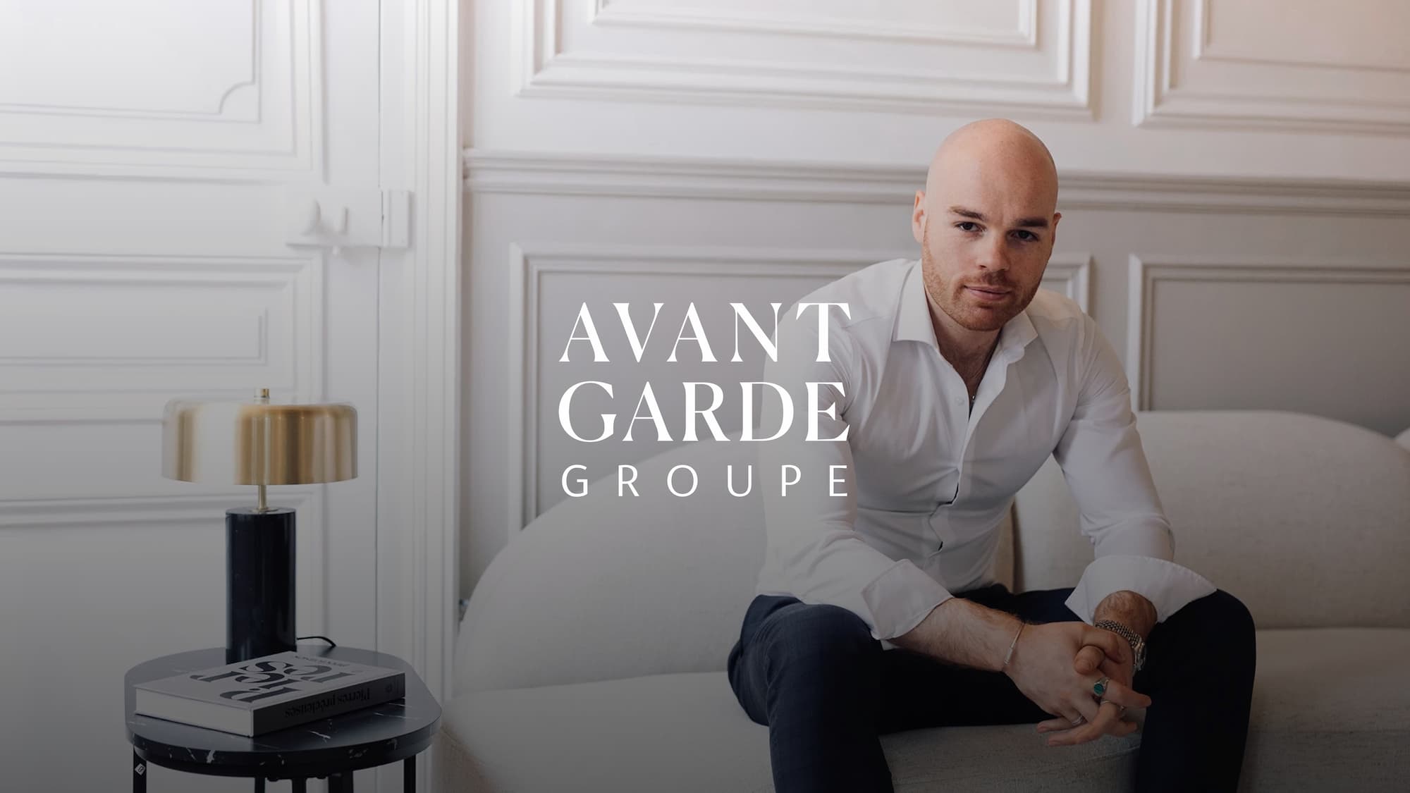 Avant-garde group band logo with Benjamin Le Maitre sitting on a sofa in the background