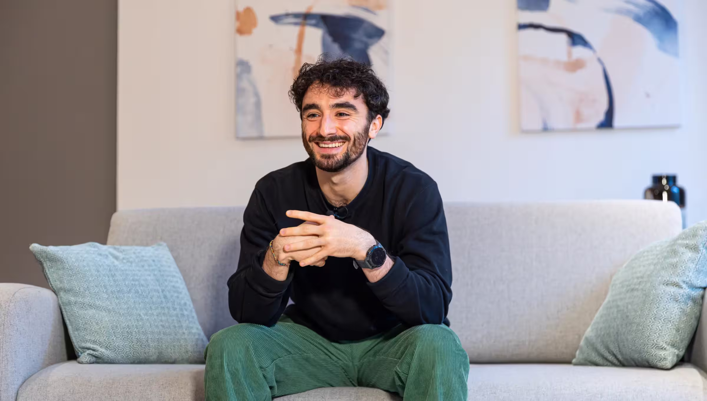 Maxime Bascon, Chief of Staff at Growl, sitting on a couch and smiling.