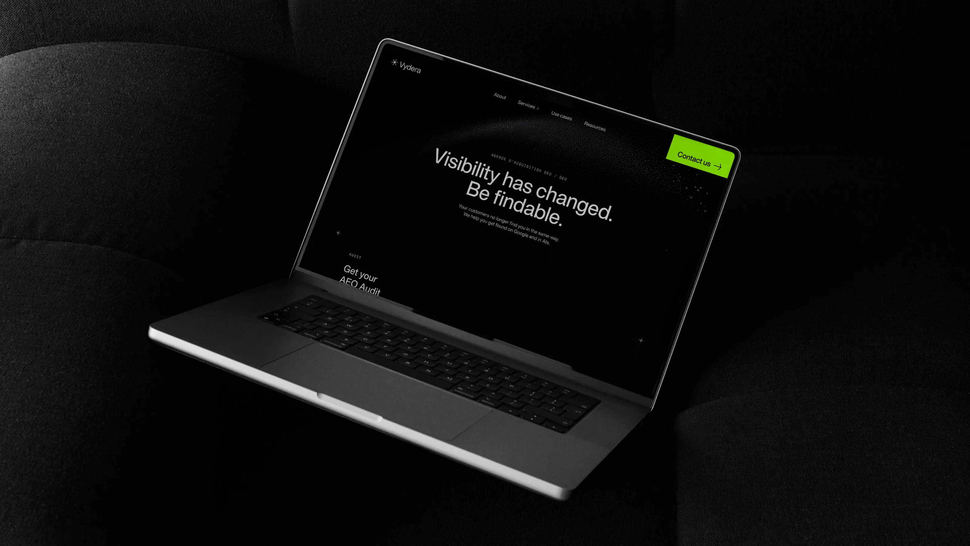 Vydera SEO & GEO agency website displayed on a computer resting on a cushion, with the headline “Visibility has changed. Be findable.”