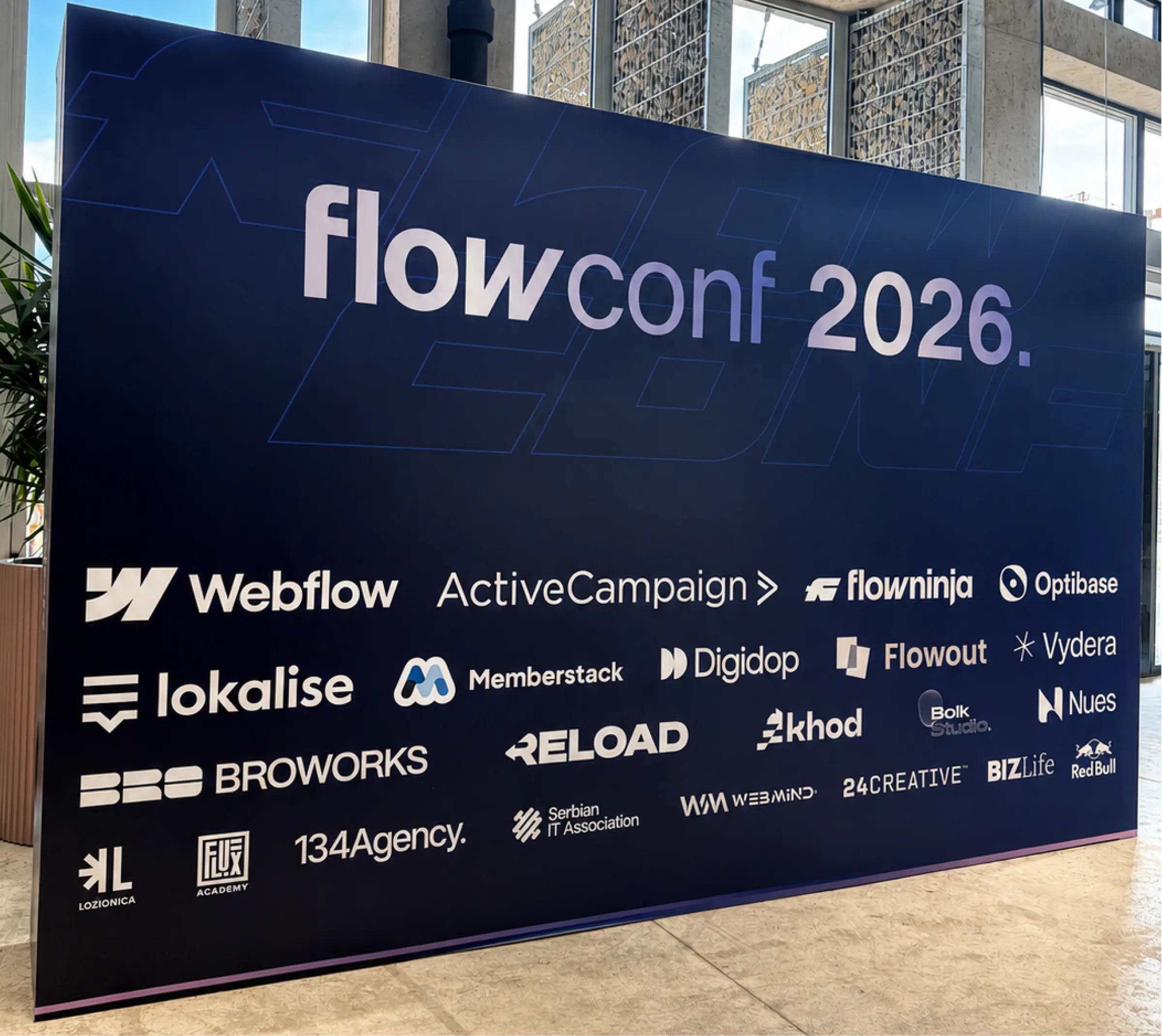 flowConf 2026 sponsor wall in Belgrade featuring partners of the Webflow and AI-focused event, including Digidop, Vydera, Webflow, and ActiveCampaign.