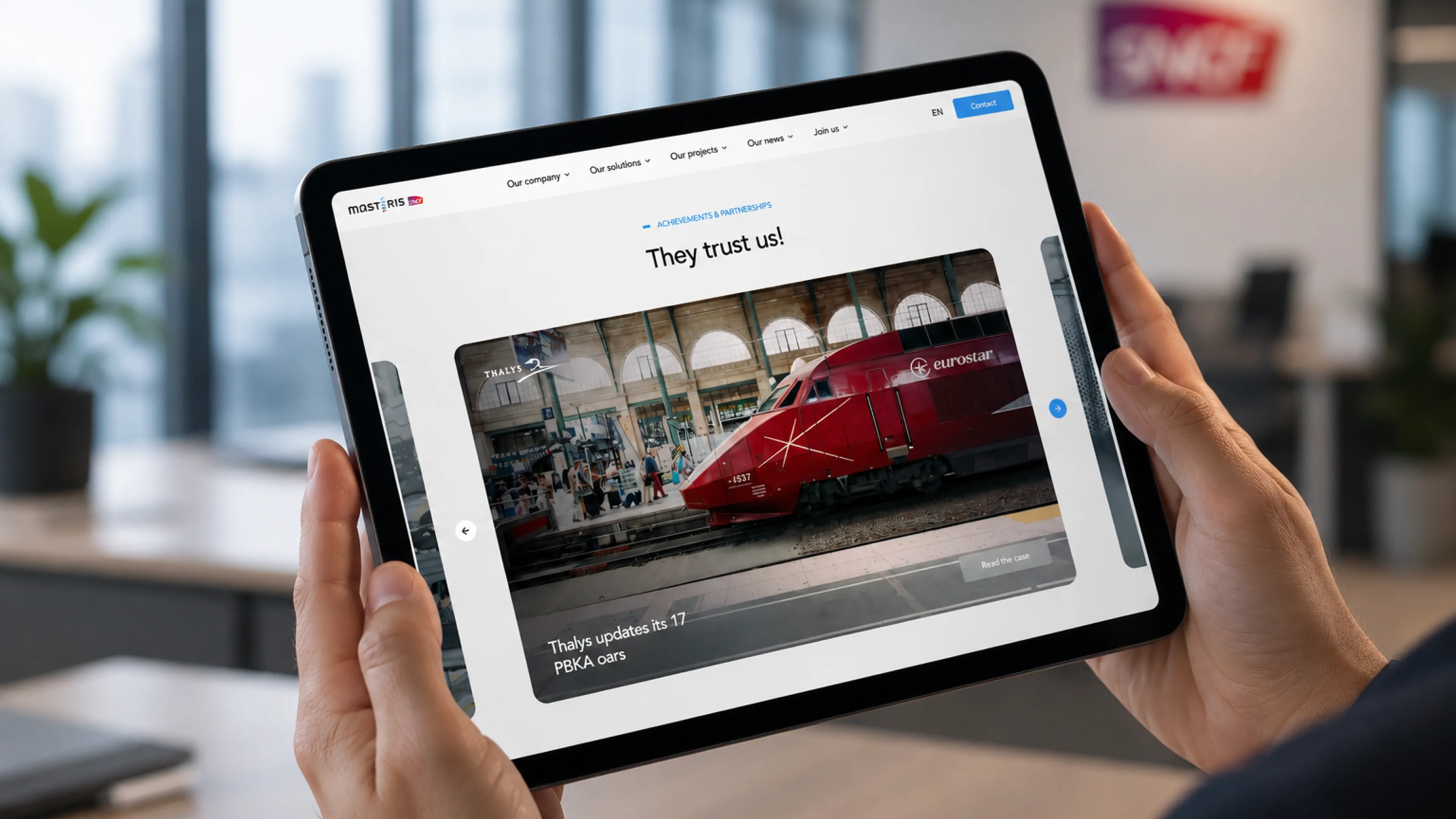 Tablet displaying the Masteris Projects page in a modern SNCF office environment, highlighting the responsive user experience built with Webflow.
