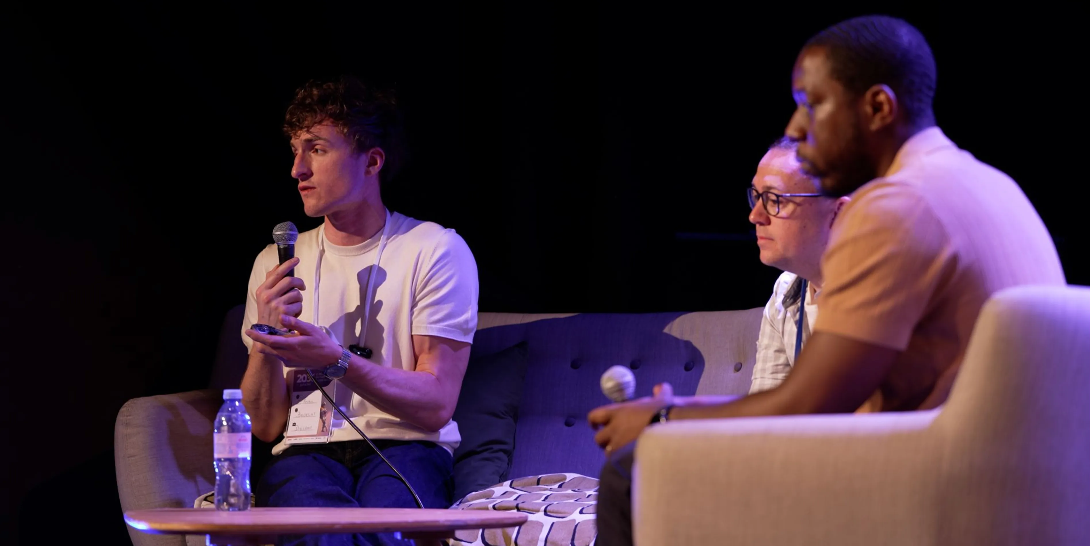 Florian Bodelot speaking during a professional conference panel alongside industry experts, discussing digital and web strategy.