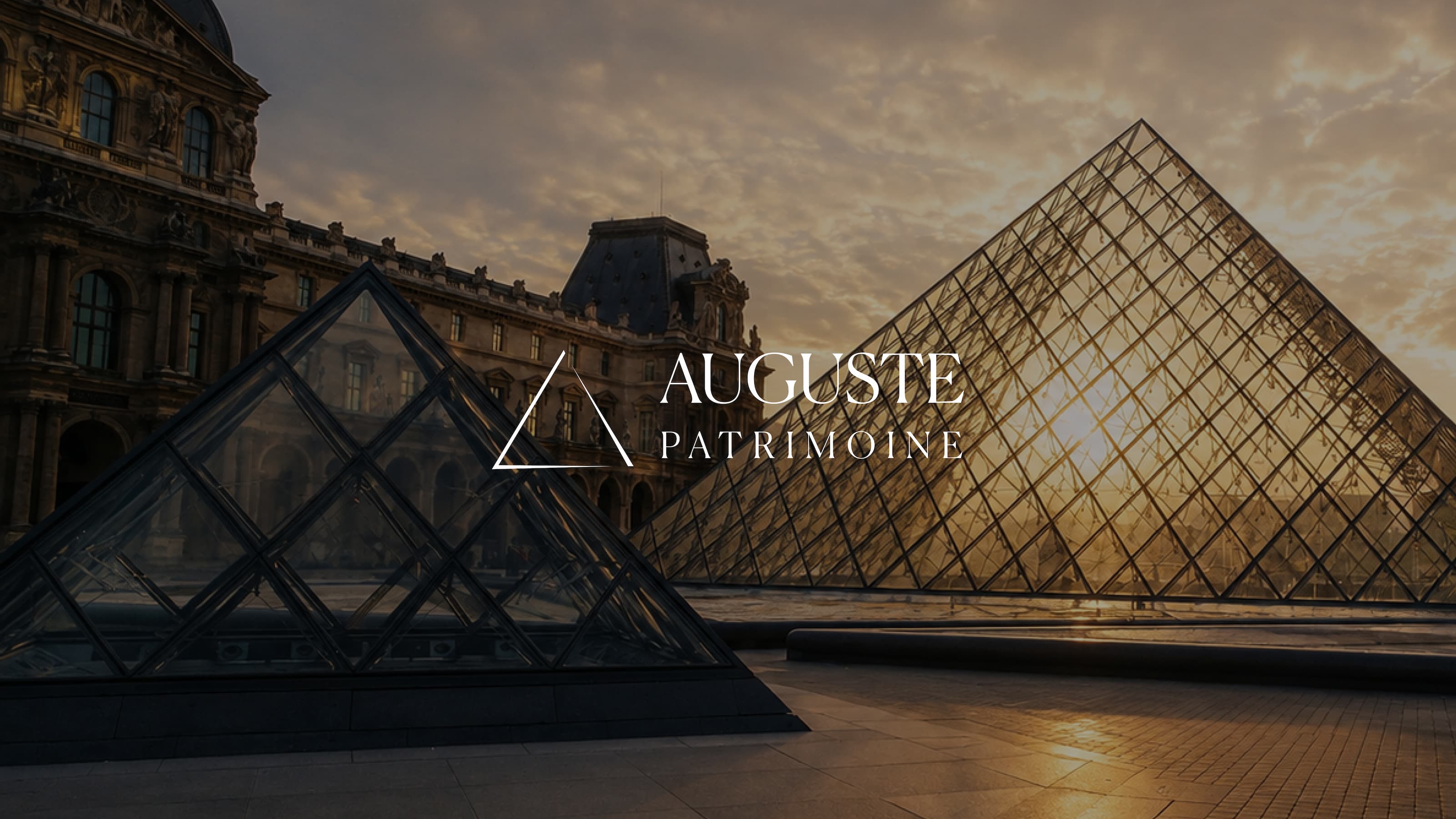 The Louvre Pyramid at sunset with the Auguste Patrimoine logo overlaid at the center, creating a refined visual that evokes heritage, wealth management, and long-term investment.