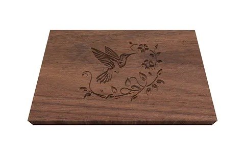 A hummingbird engraved on a walnut box lid.