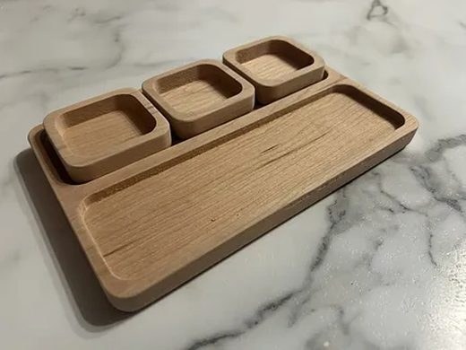 A cherry bar tray with recessed compartments.