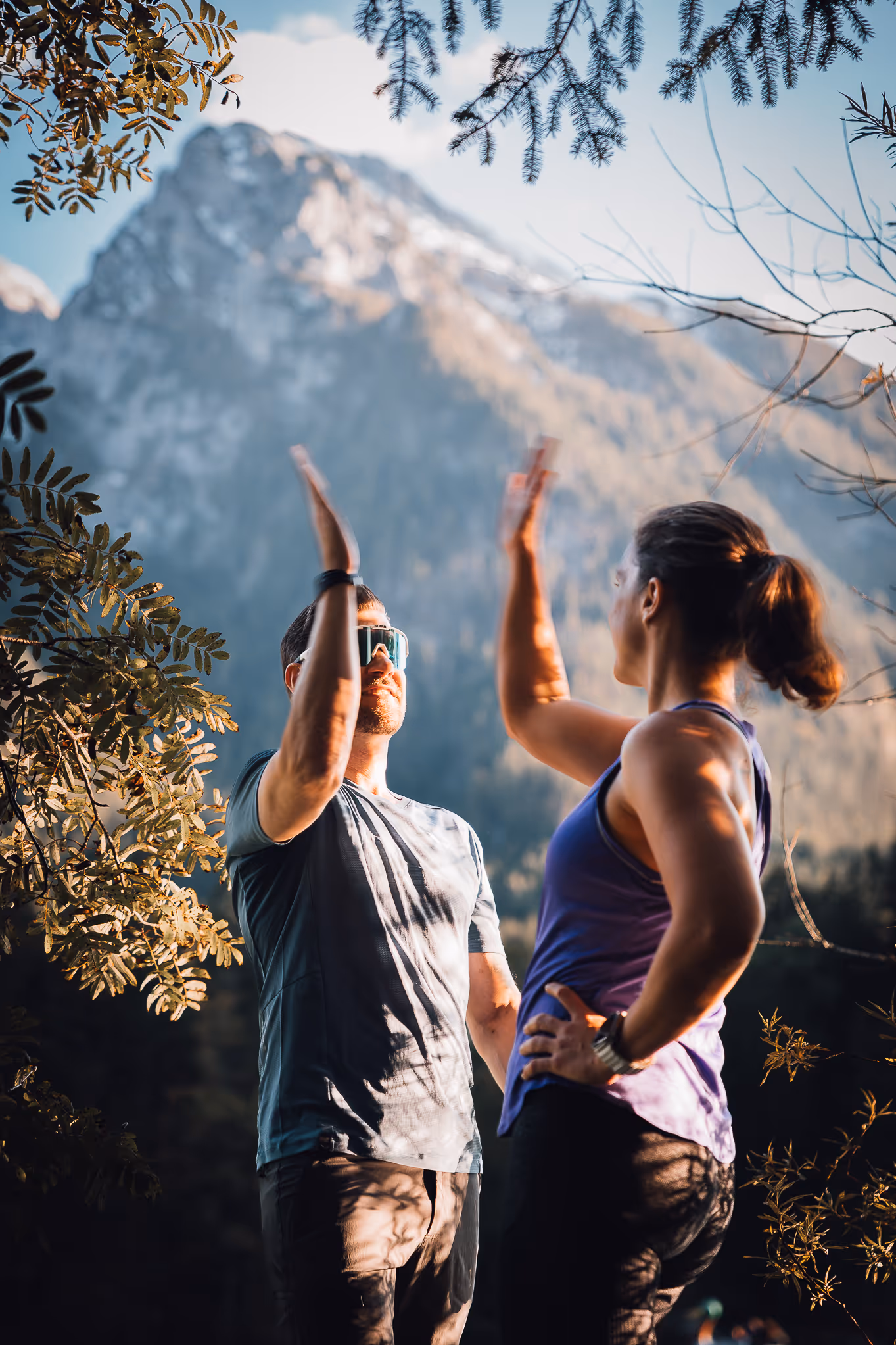 Two people successfully clapping hands outdoorss.