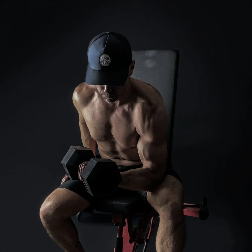 Justin doing a seated dumbbell curl on a bench