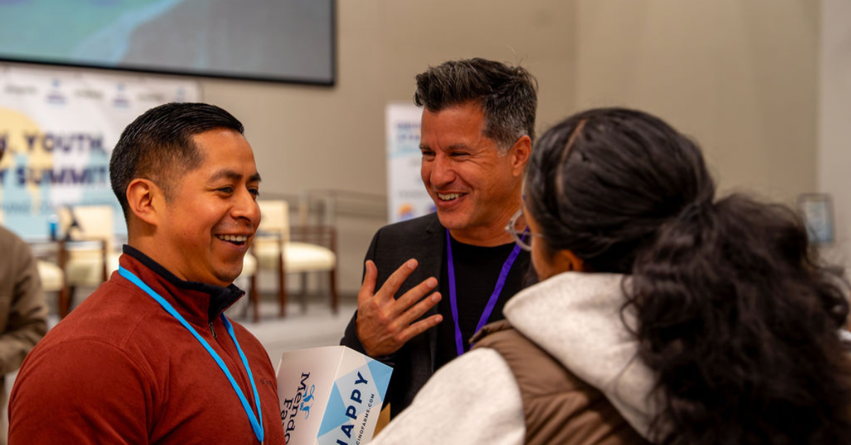 3 people smiling and chatting