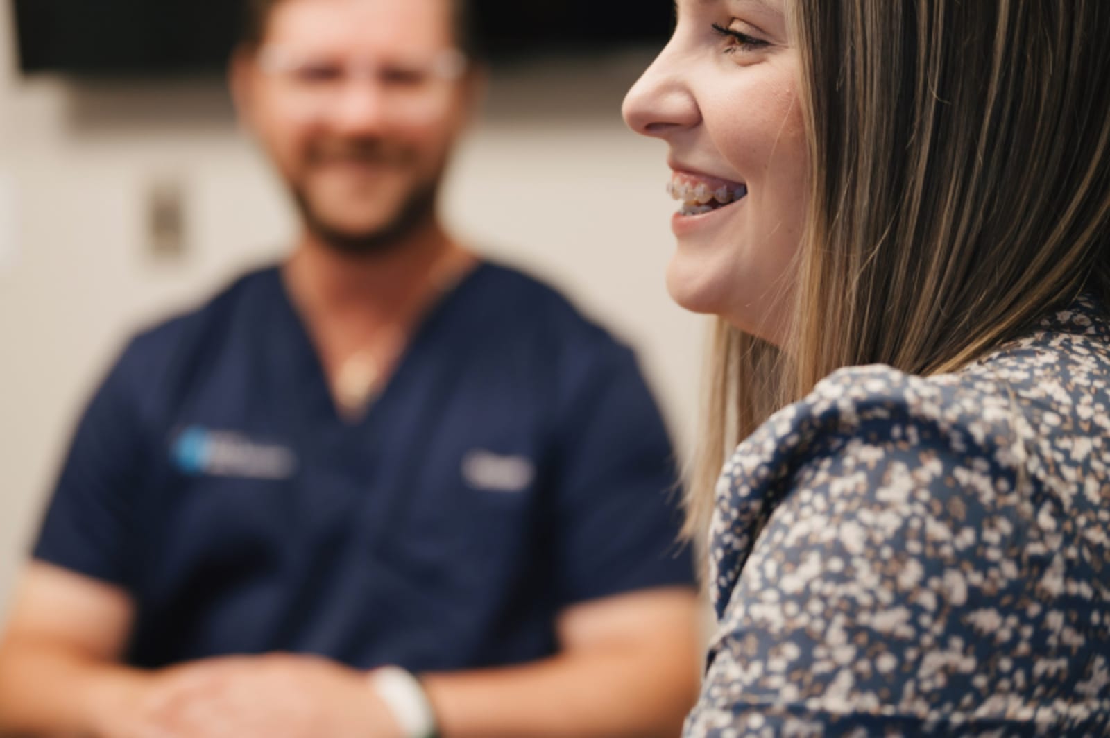 Patient smiling while speaking with dentist, showing comfort and trust during care