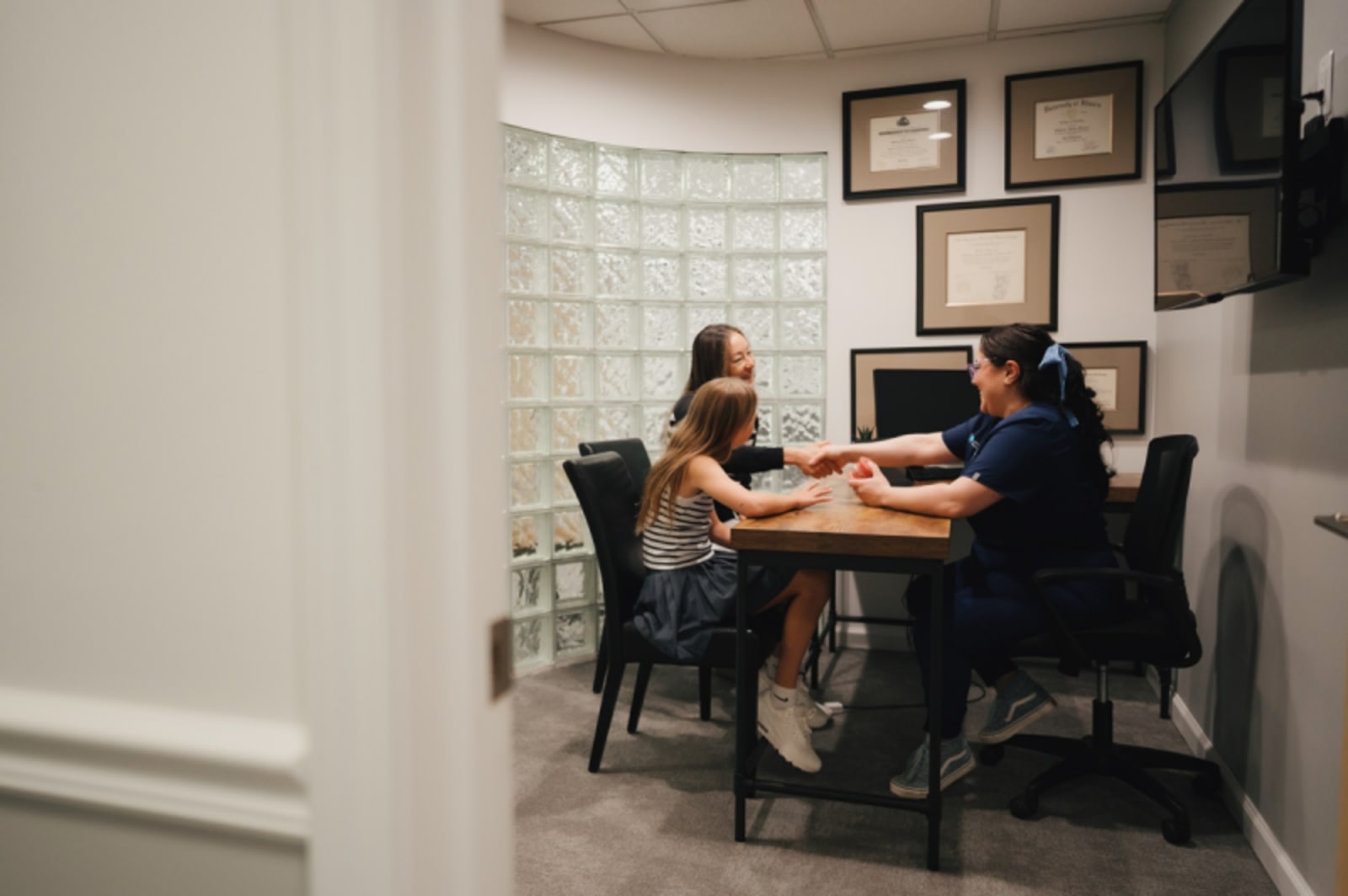 Team members collaborating at a desk in a professional dental office setting