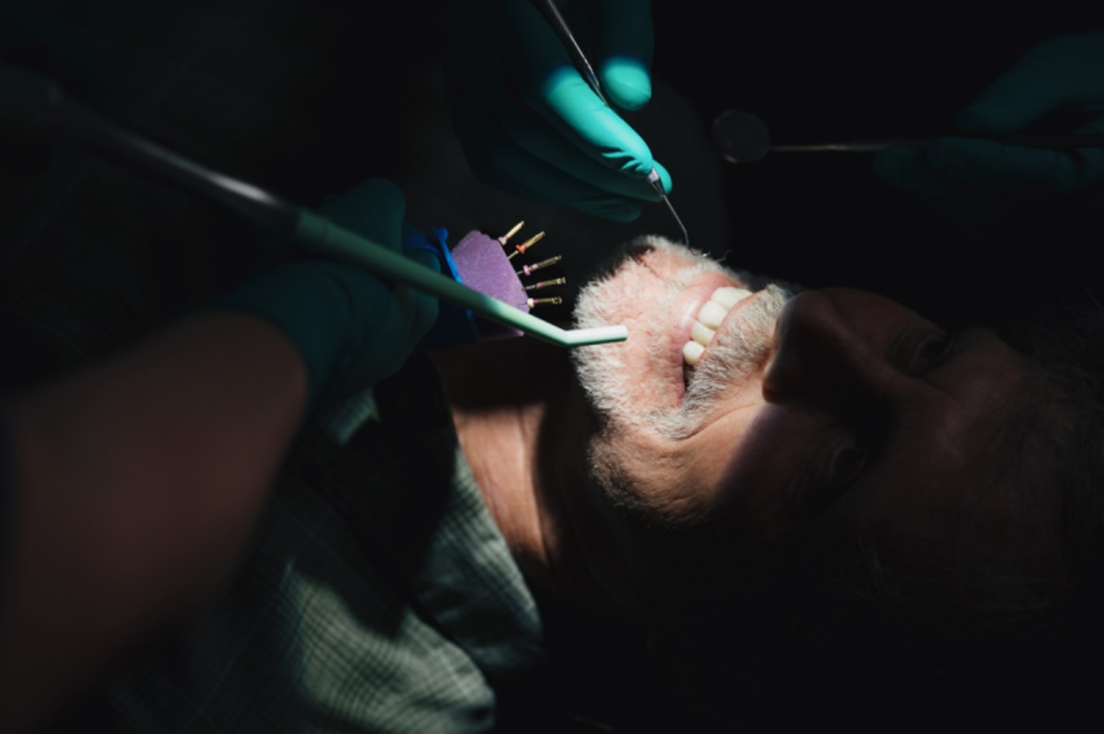 Endodontist performing dental procedure on patient with specialized equipment