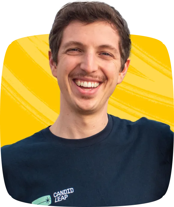 A man wearing a blue shirt with a Candid Leap logo on it.