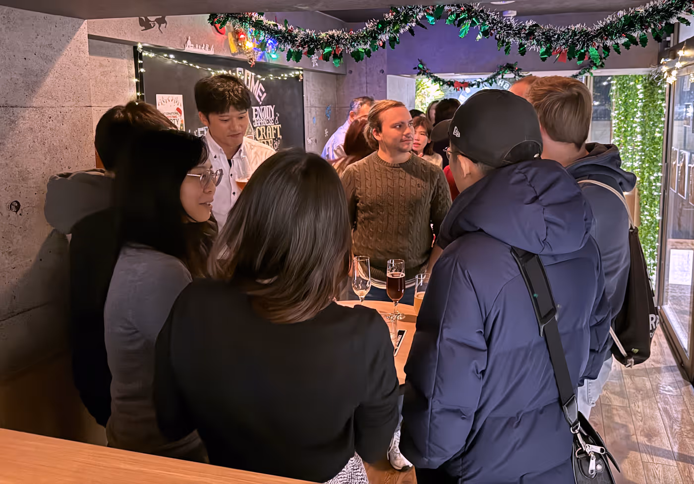 A crowd of people at night inside of a small event venue.